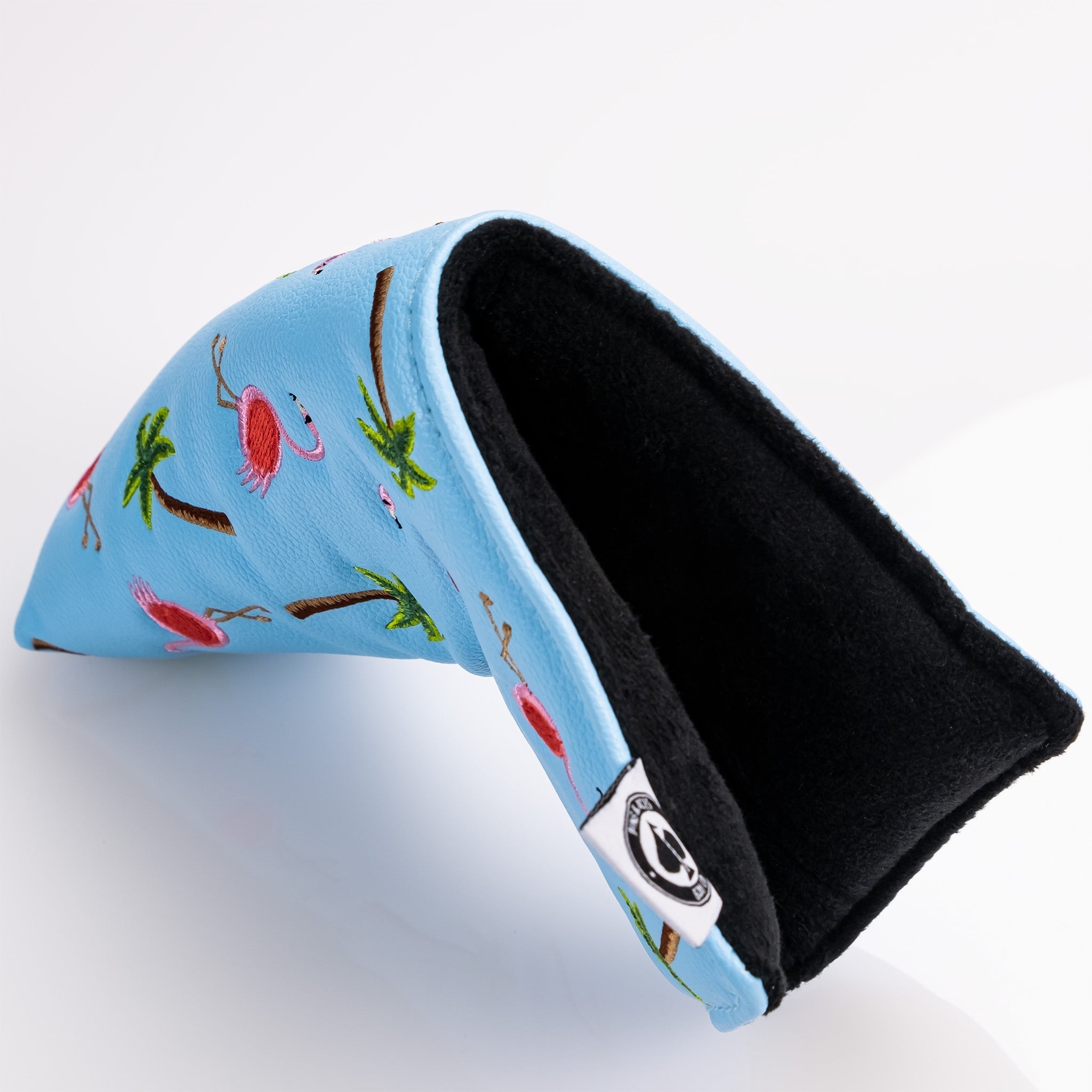 Dancing Flamingos blade putter cover featuring a vibrant blue design with embroidered flamingos and palm trees.