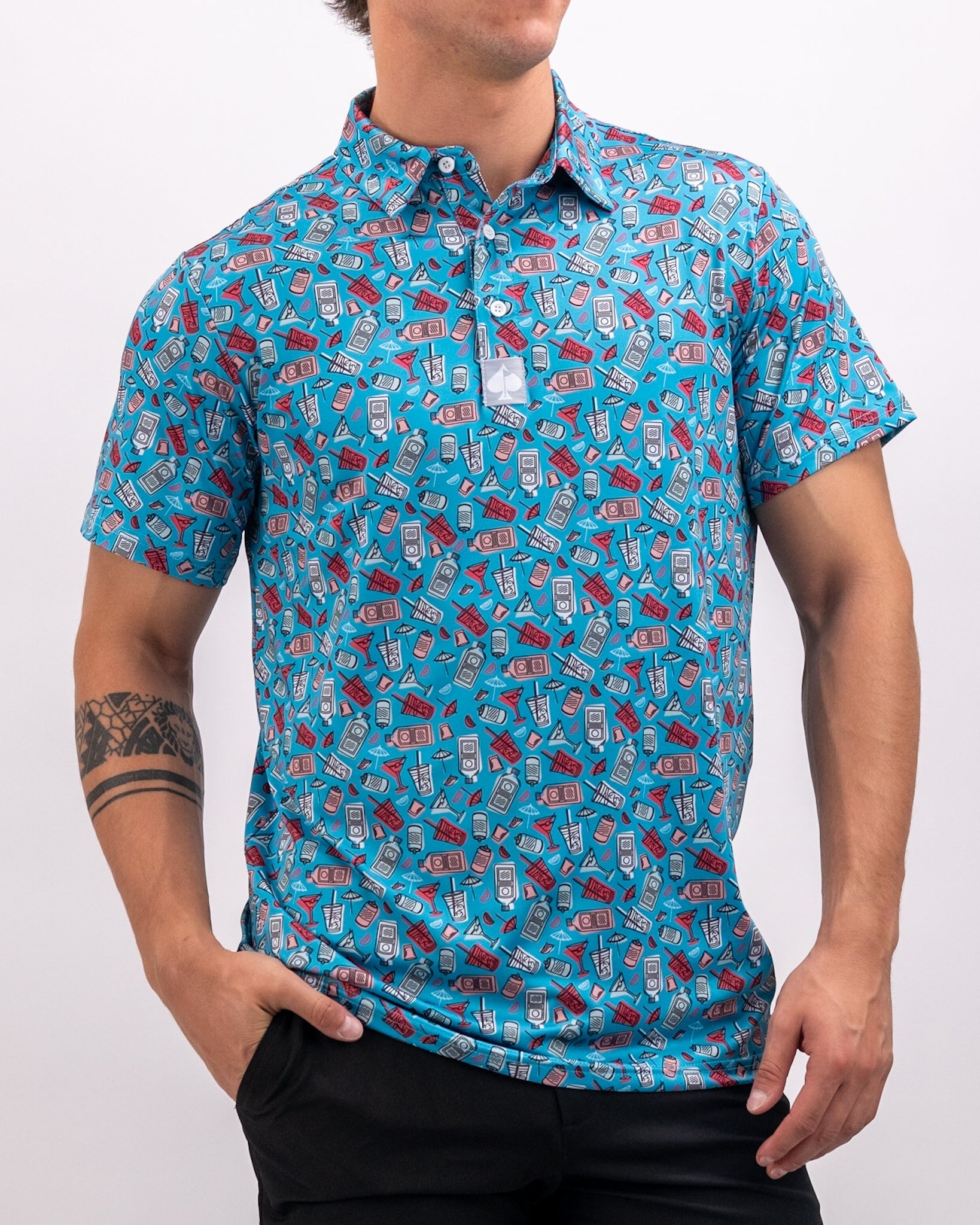 Bold blue golf polo featuring a playful pattern of drinks and golf accessories, perfect for stylish day outings on the course.