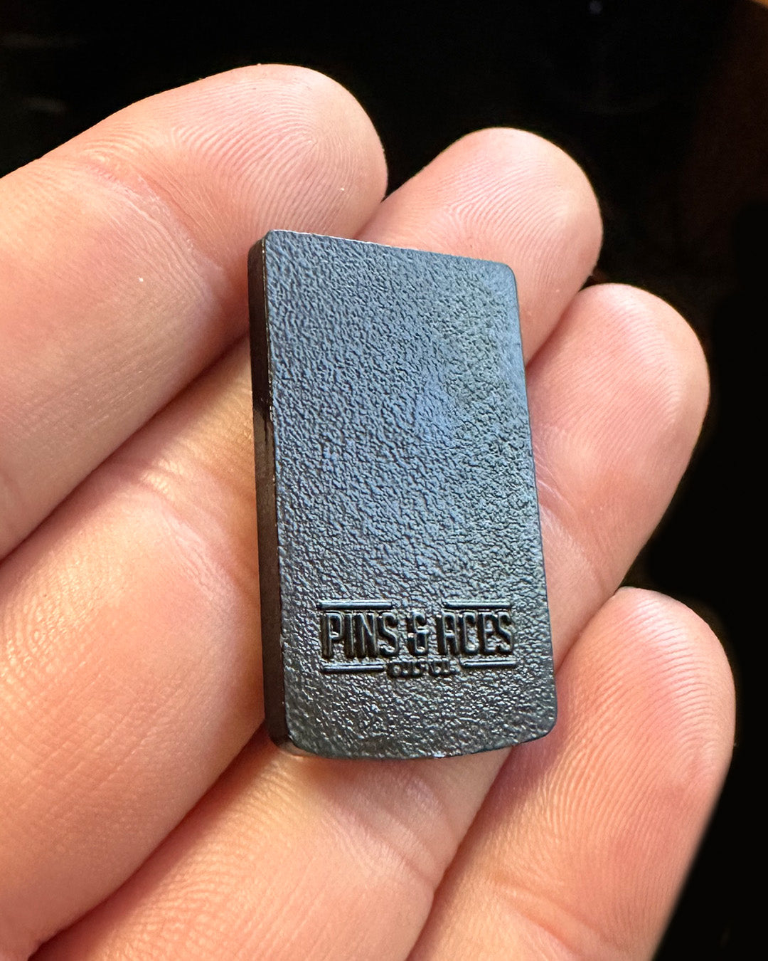 Game Boy ball marker featuring a textured black design, perfect for adding a playful touch to your golf game.