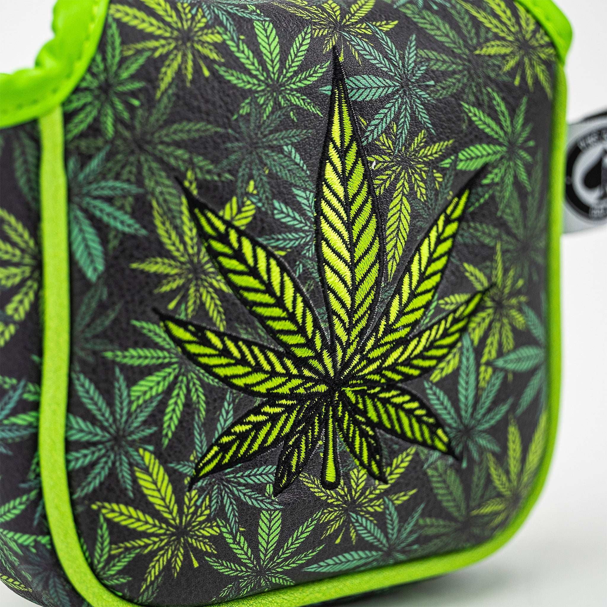 Bold mallet putter cover featuring a vibrant green cannabis leaf design on a black background, perfect for high handicappers.