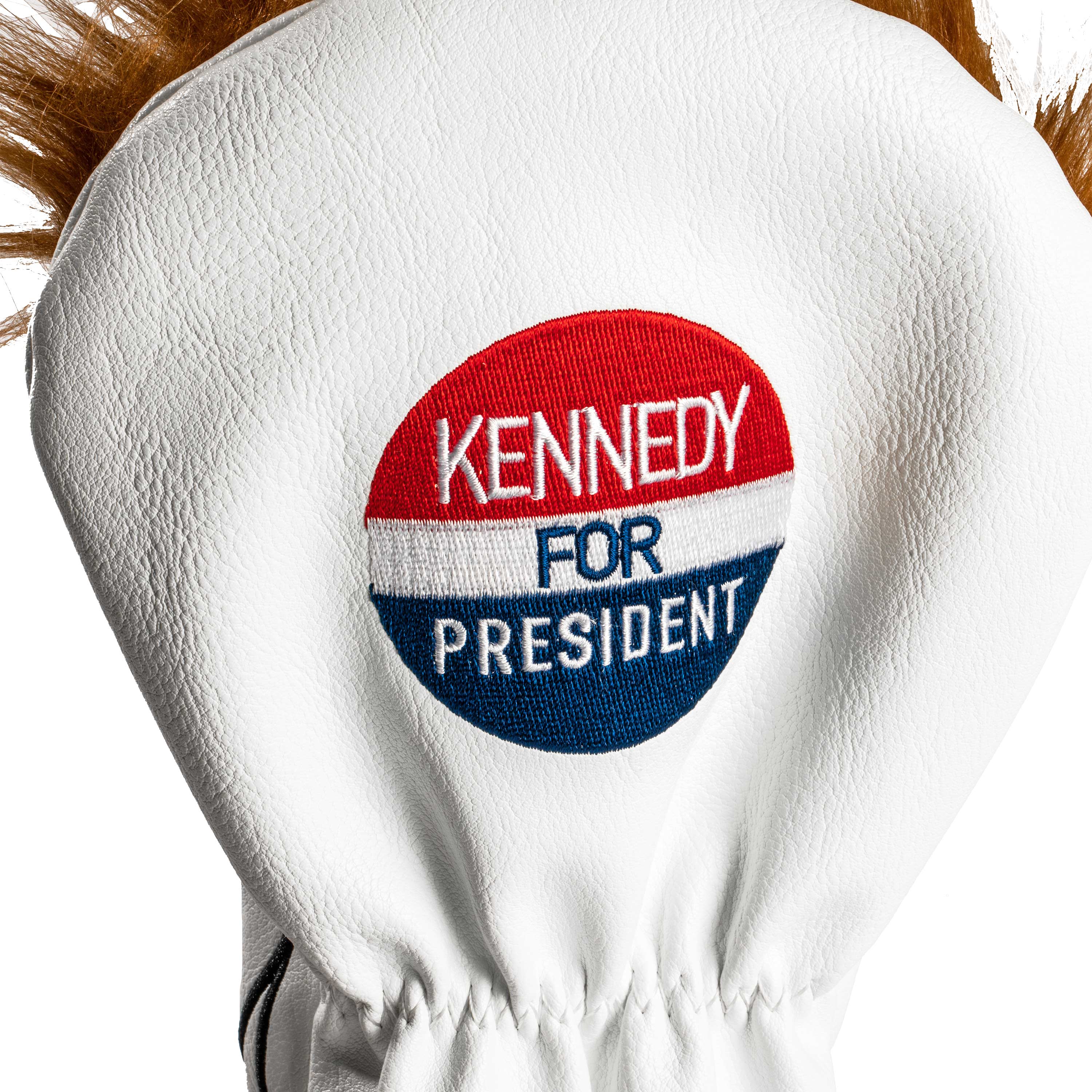 White driver cover featuring a vintage "Kennedy for President" patch in red, white, and blue colors.