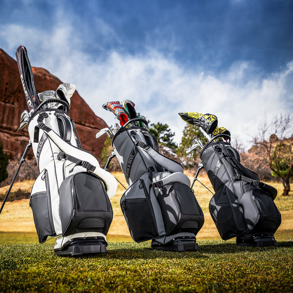Colorful golf headcovers and accessories on golf bags with bold designs, perfect for standing out on the course.