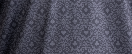 Elegant dark fabric featuring a subtle pattern of playing card symbols, perfect for bold golf apparel.