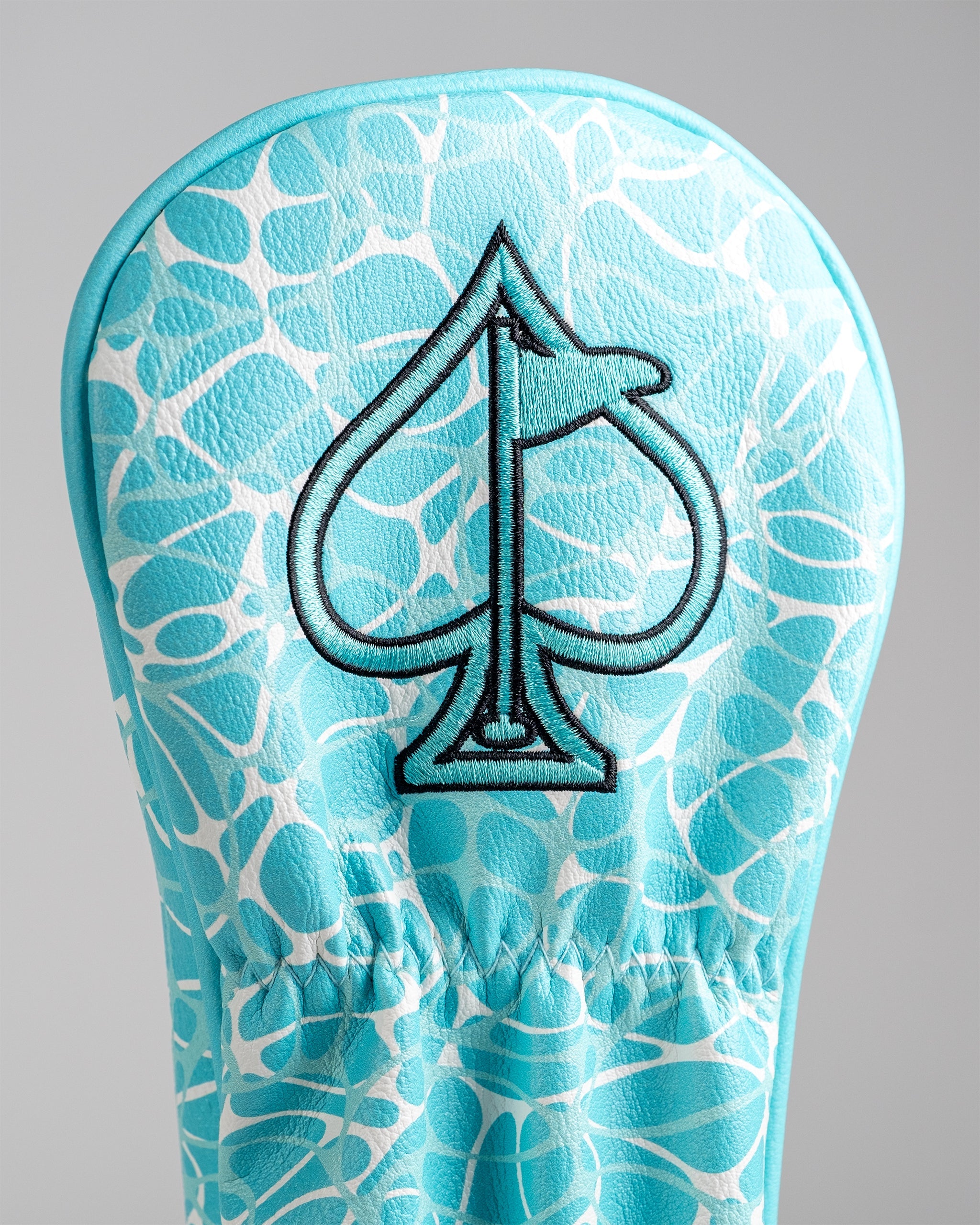 Kraken fairway cover featuring a bold spade logo on a vibrant turquoise background with a unique pattern.