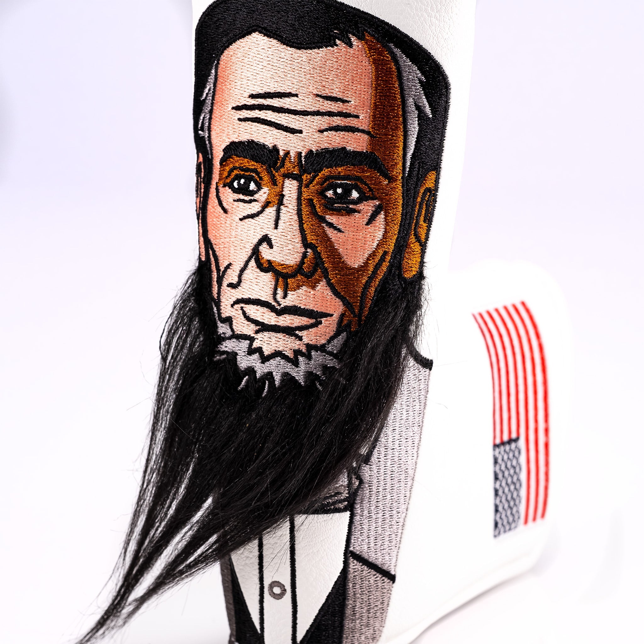 Lincoln Blade Putter Cover featuring detailed embroidery of Abraham Lincoln's face and a textured beard, designed for golfers.