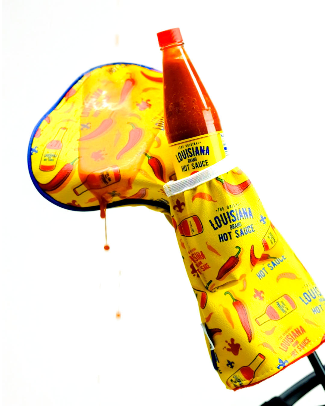 Bright yellow driver cover featuring Louisiana Hot Sauce graphics, designed for golfers who want to add flair to their game.