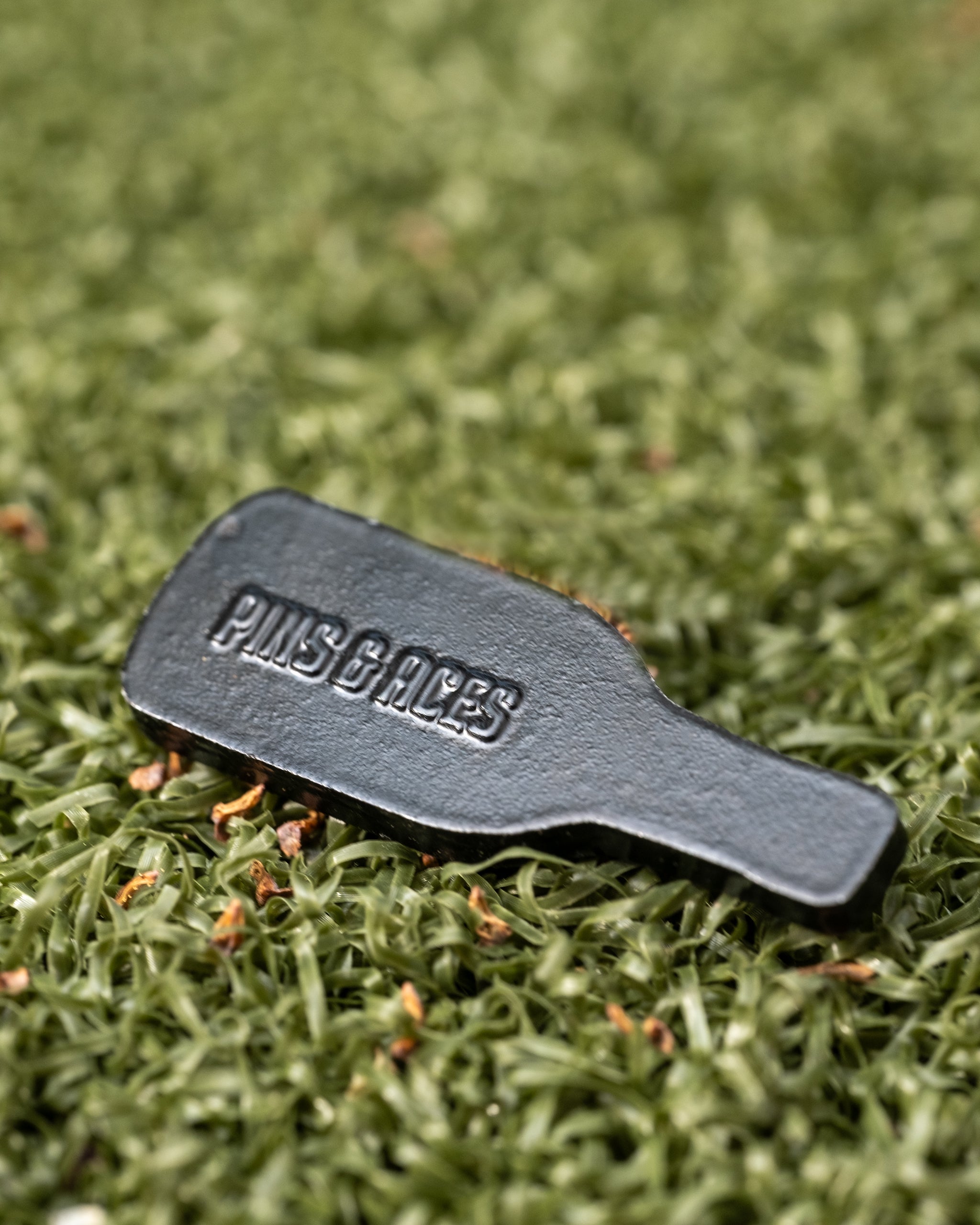 Louisiana Hot Sauce ball marker featuring a sleek design with the Pins and Aces logo for stylish golfing.