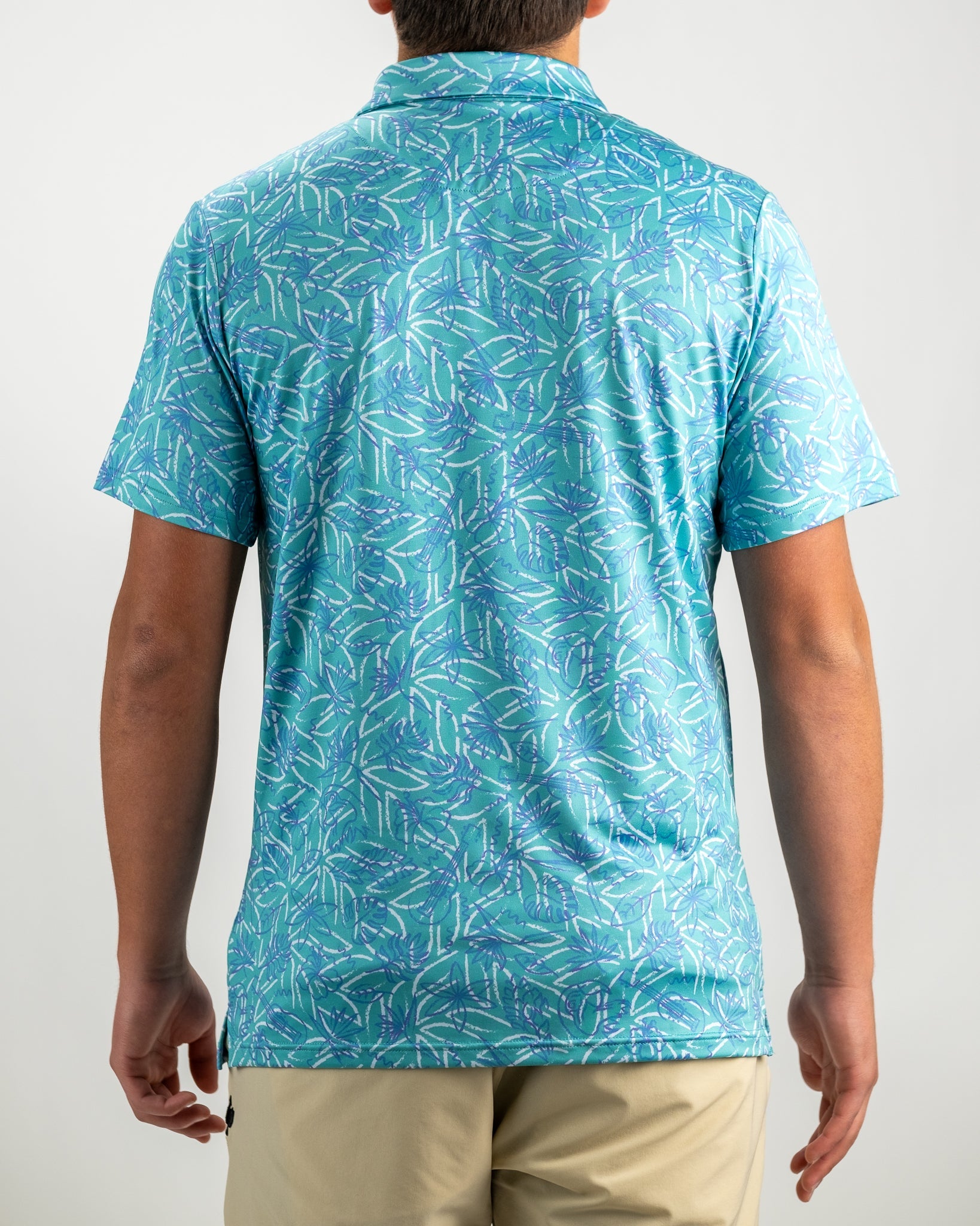 Men's Margaritaville 5 O'Clock Ocean shirt featuring a vibrant tropical leaf pattern in shades of blue and green.