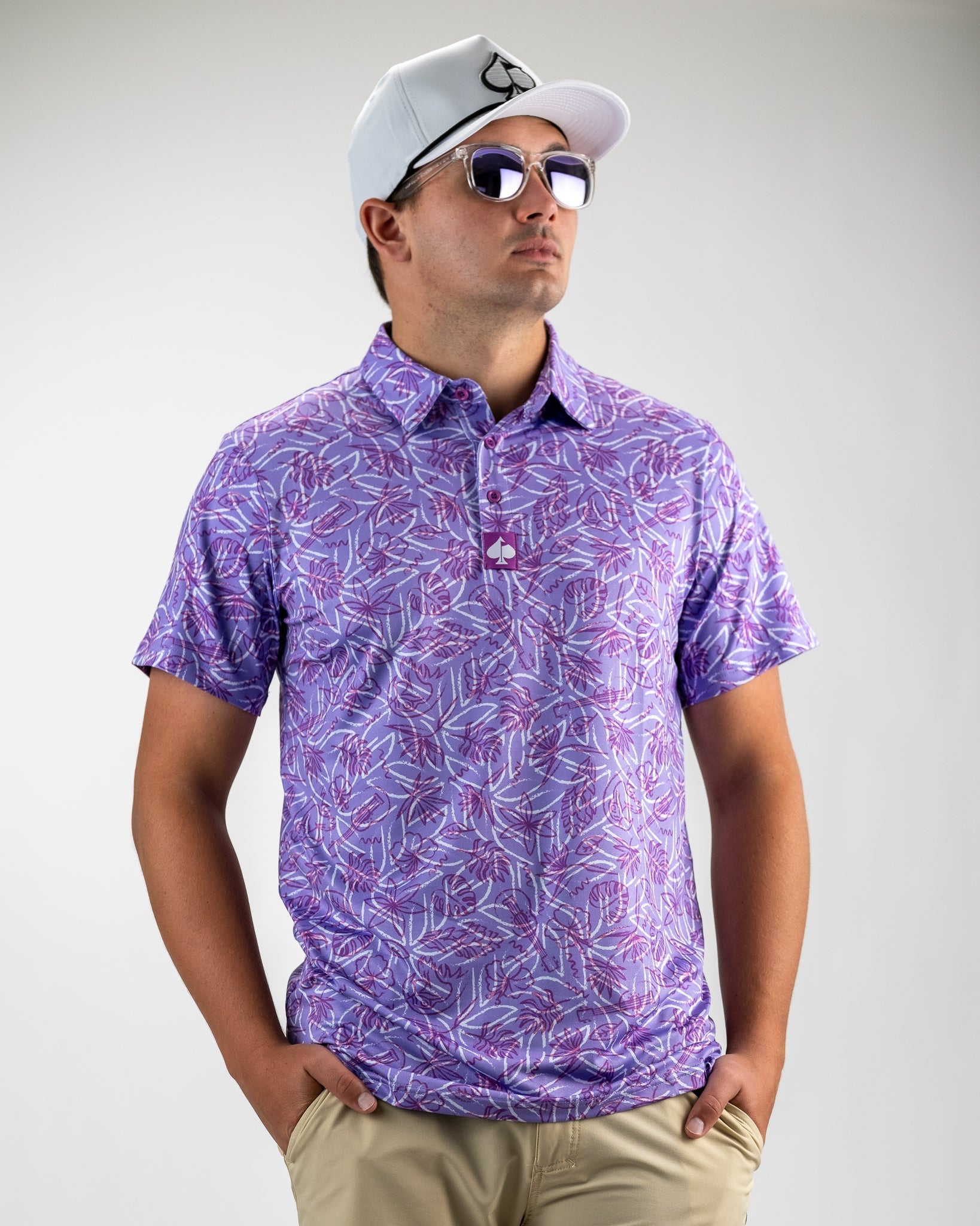 Men's Margaritaville 5 O'Clock Sunset polo shirt featuring a vibrant purple leaf pattern, perfect for stylish golf outings.