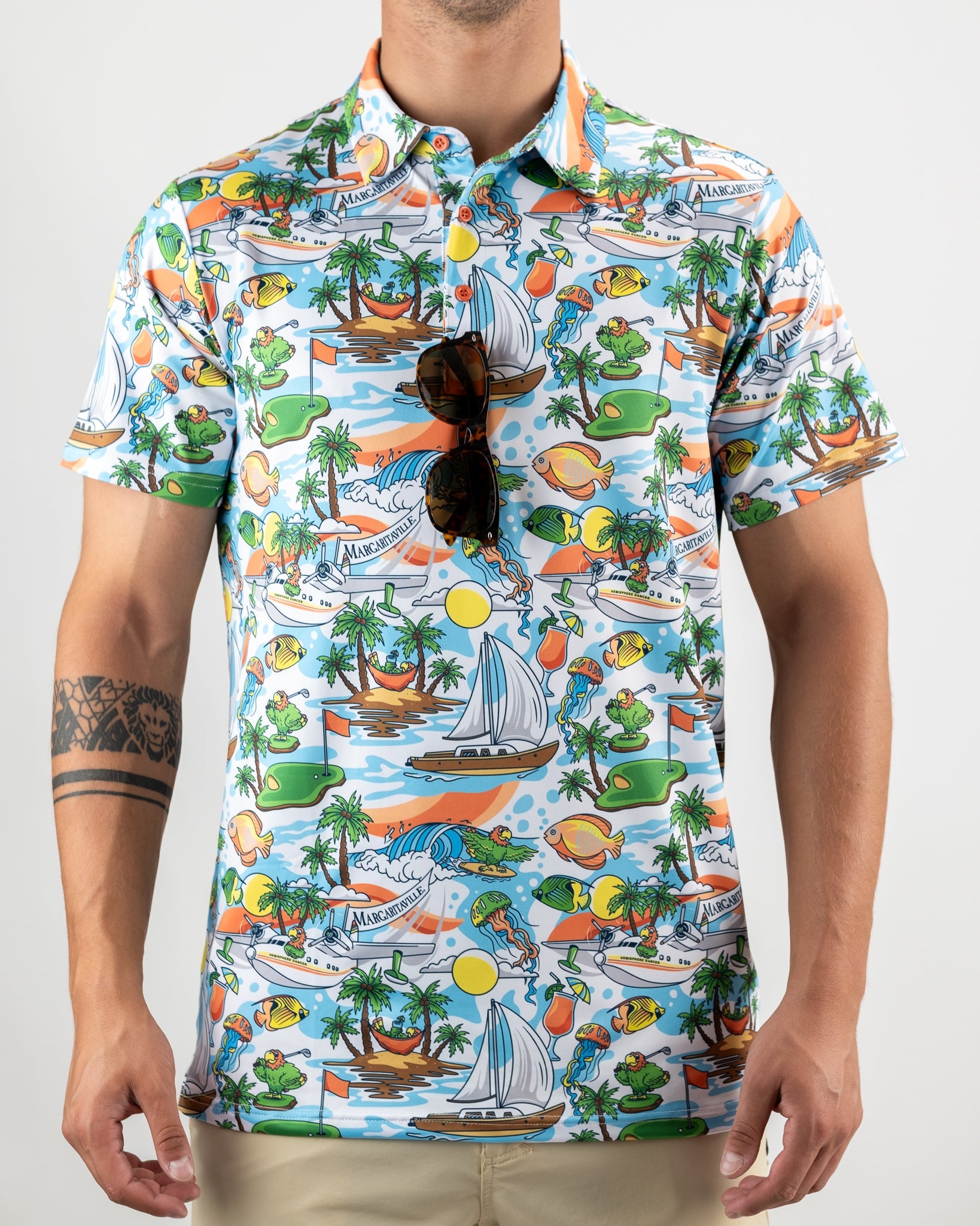 Colorful Margaritaville shirt featuring tropical designs with boats, palm trees, and playful characters, perfect for golf enthusiasts.