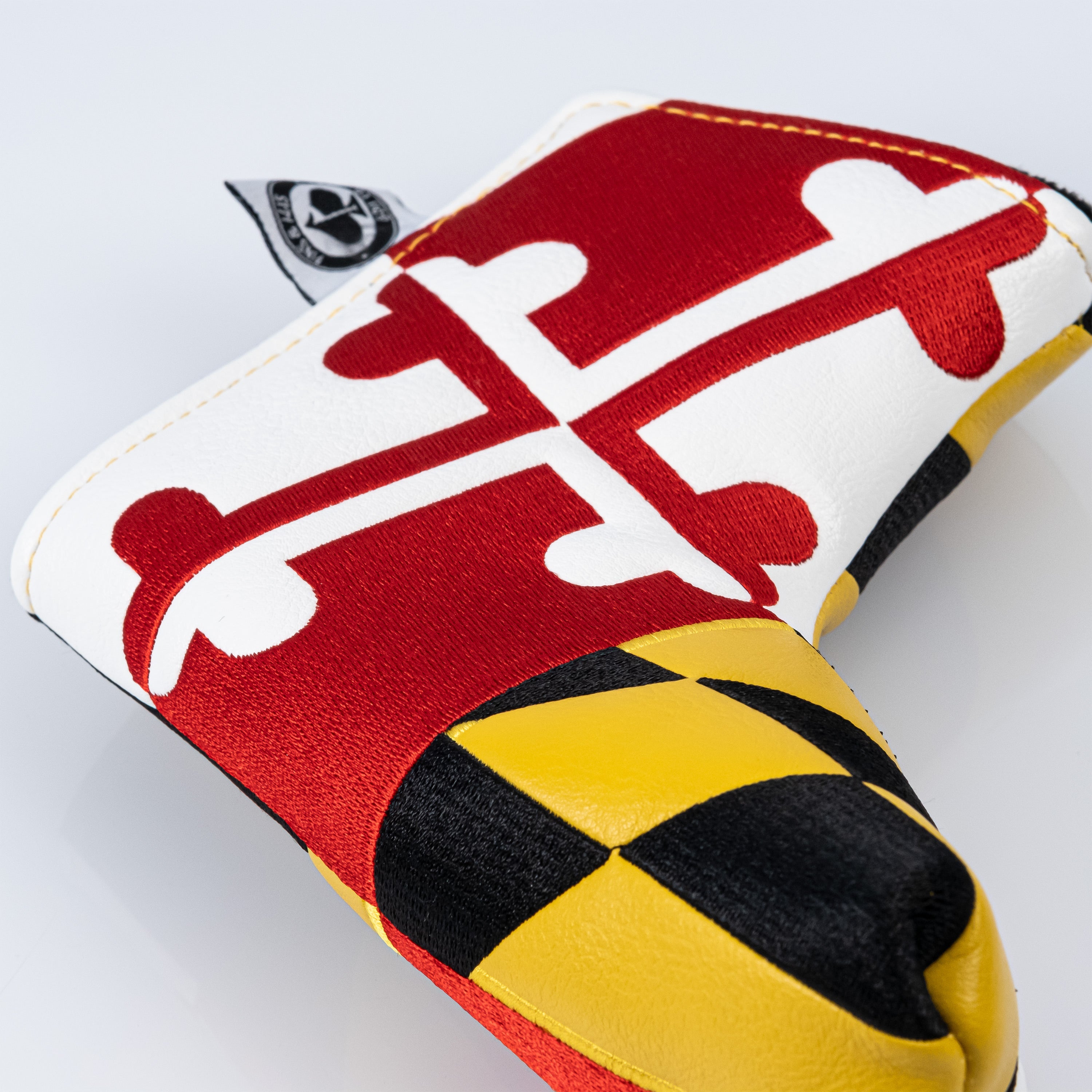 Maryland blade putter cover featuring the state flag design in bold red, white, black, and yellow colors.