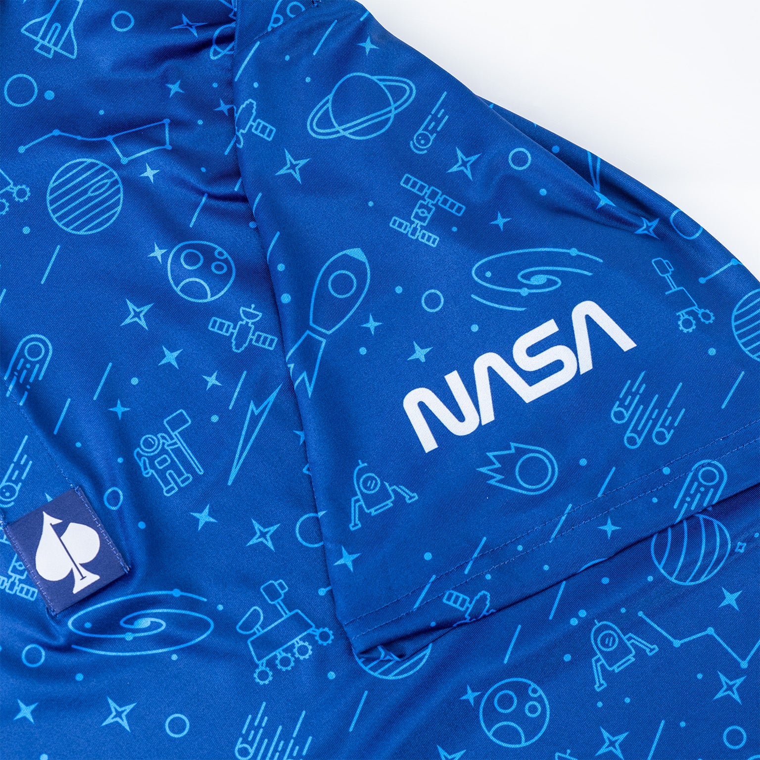 Bold blue NASA polo featuring a space-themed pattern with rockets, planets, and stars, perfect for golf enthusiasts.