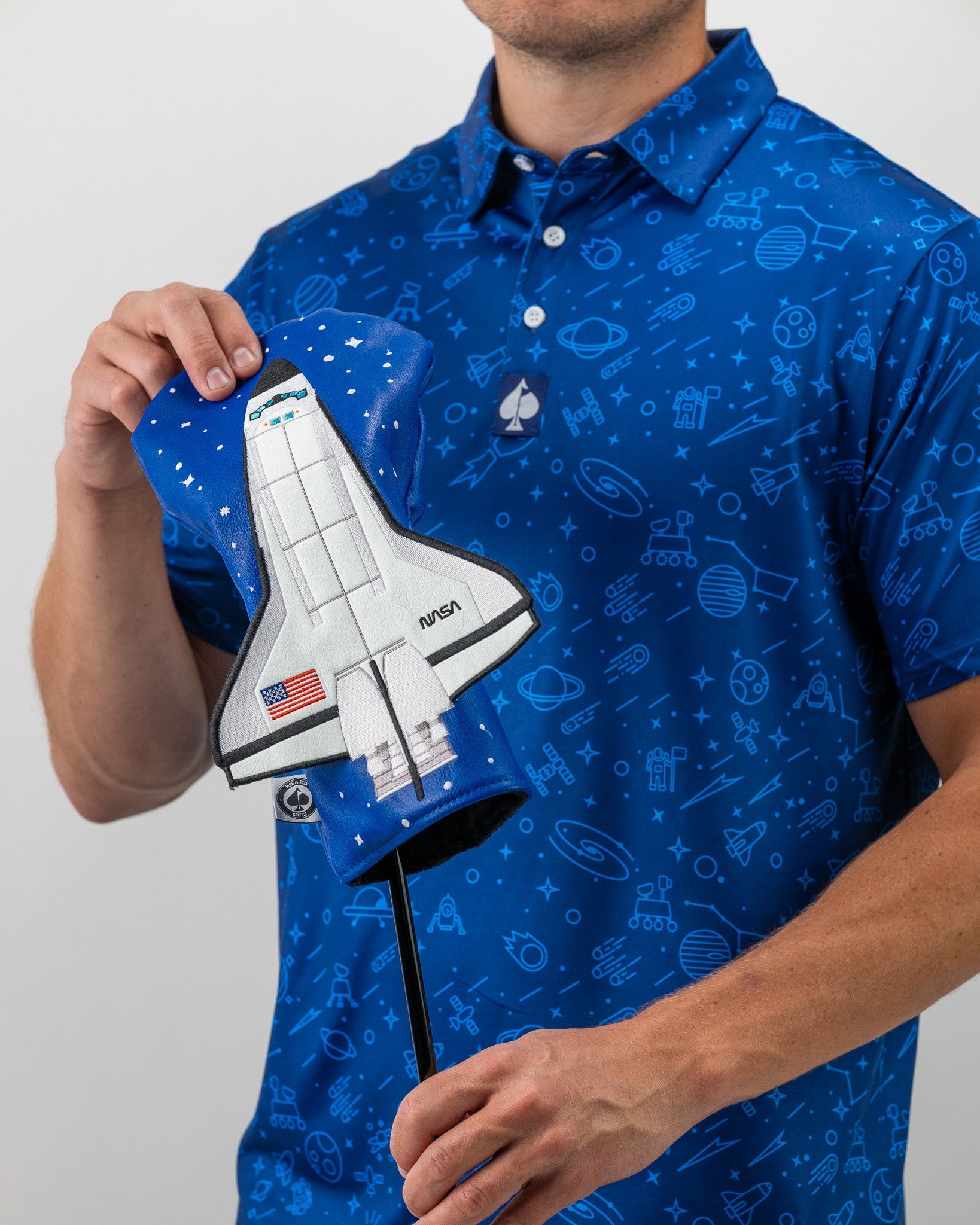 Bold blue NASA polo featuring space-themed graphics, paired with a unique space shuttle headcover.