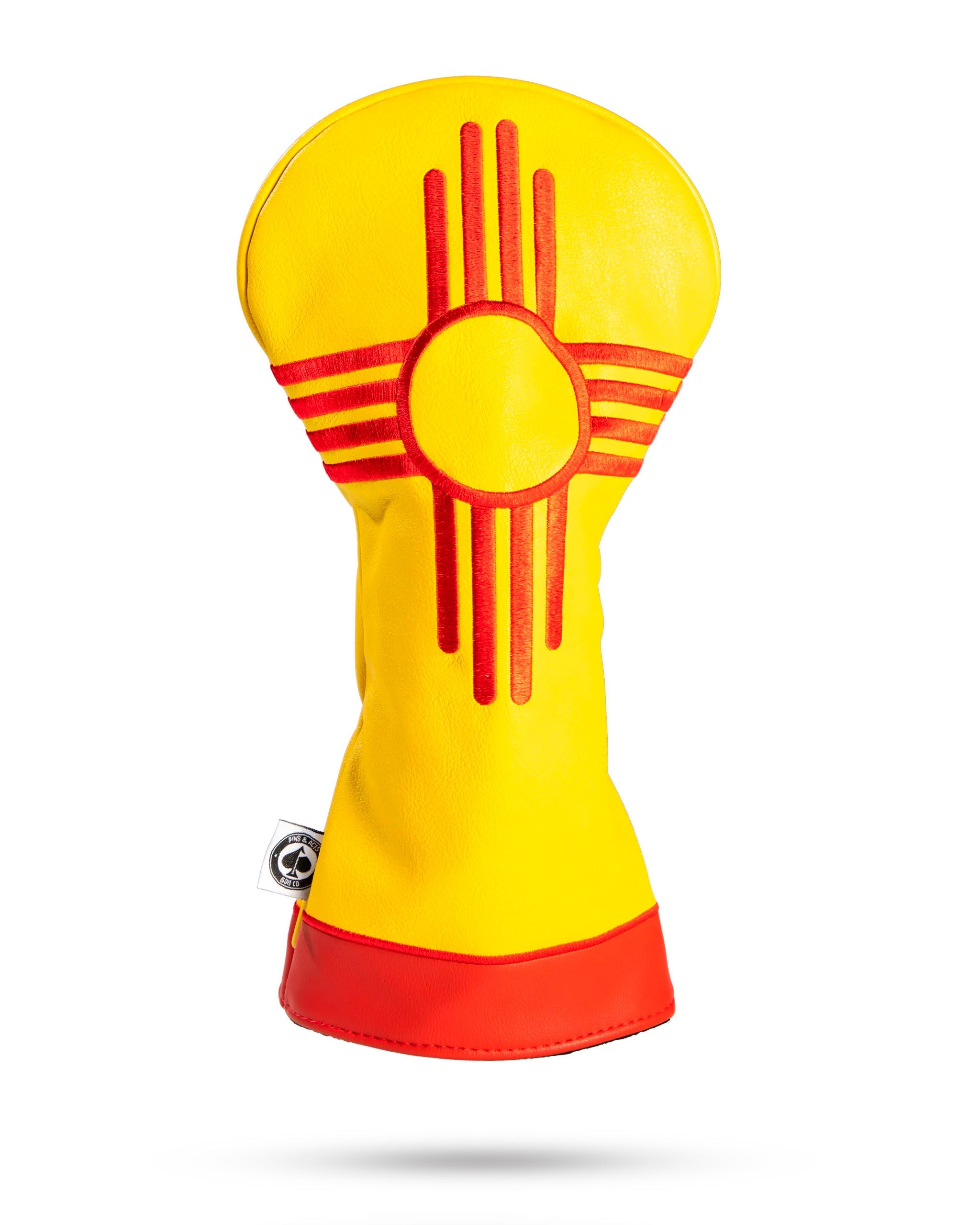 New Mexico State Flag driver cover featuring a vibrant yellow background with a red Zia sun symbol.