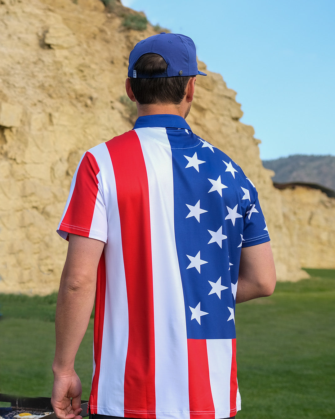 Bold golf polo featuring a patriotic design with red and white stripes and blue star pattern, perfect for stylish golfers.