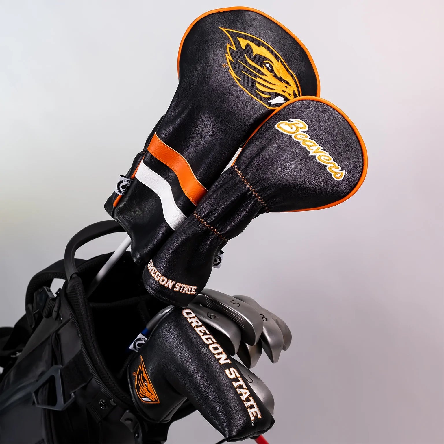 Oregon State University blade putter cover featuring a black design with orange accents and Beaver logo, ideal for golf enthusiasts.