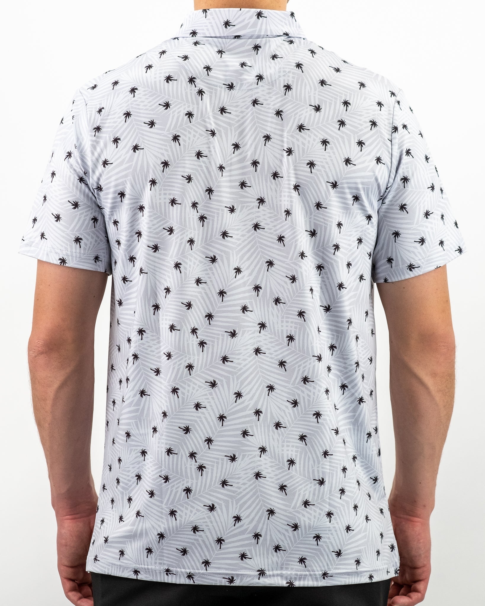 Men's short-sleeve golf shirt featuring a light blue background with a repeating palm tree pattern, ideal for stylish play.