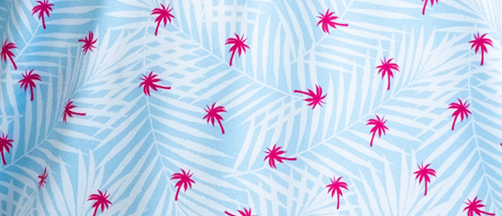 Light blue fabric featuring a pattern of white palm leaves and vibrant pink palm trees, perfect for bold golf apparel.