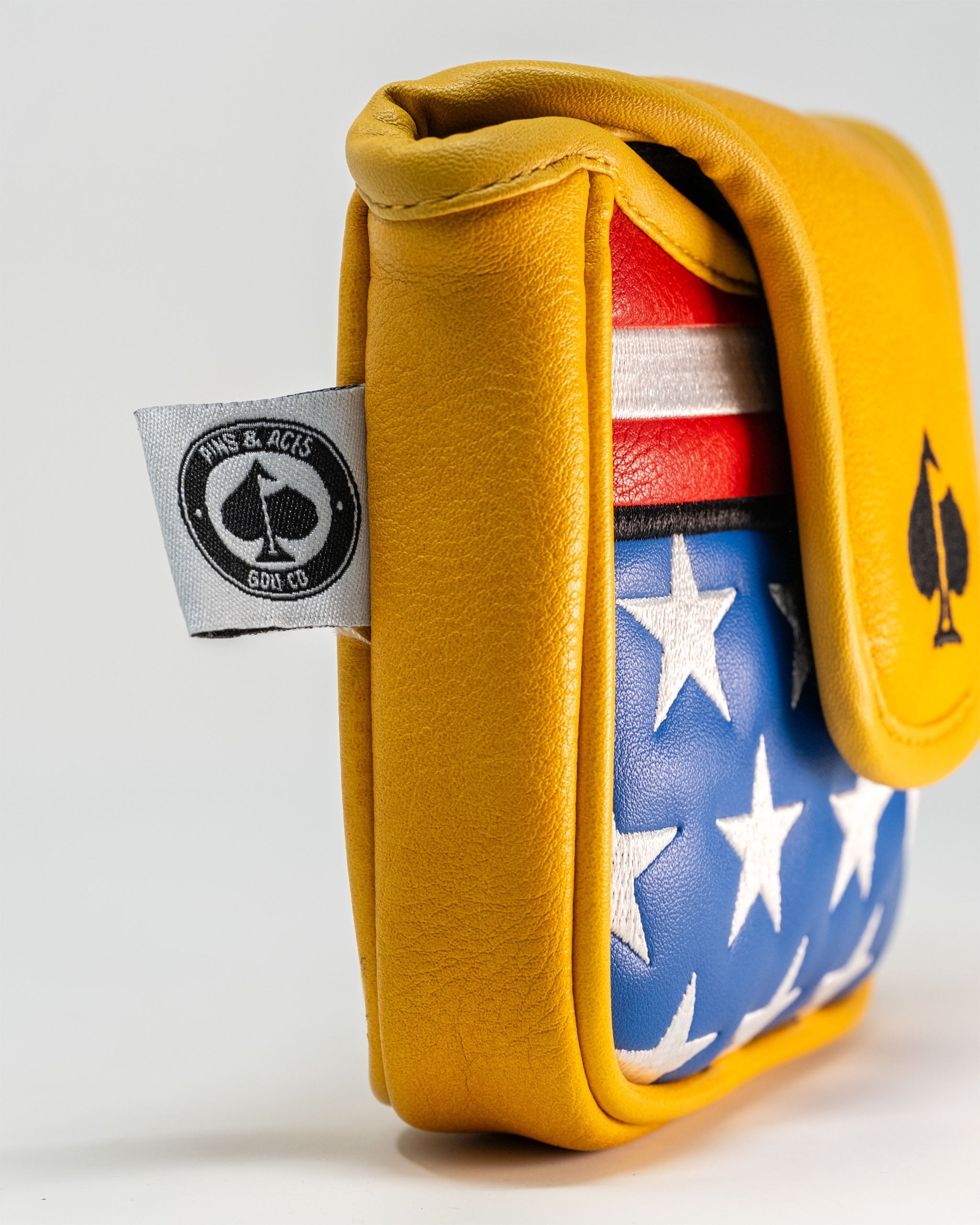 Bold yellow mallet cover featuring a patriotic design with red, white, and blue stars and stripes. Ideal for golfers.