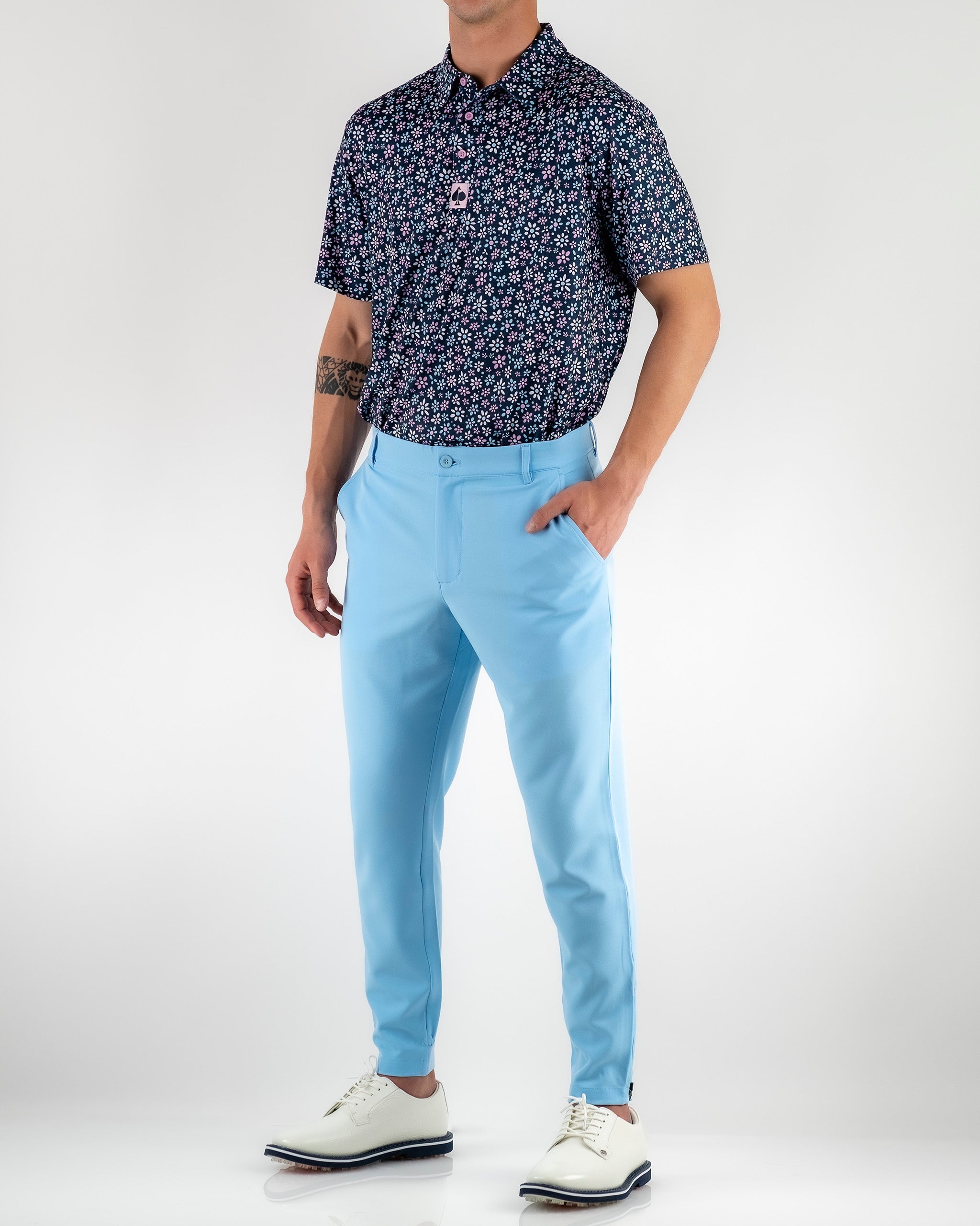 Sky blue performance jogger paired with a floral print polo, ideal for stylish comfort on the golf course.