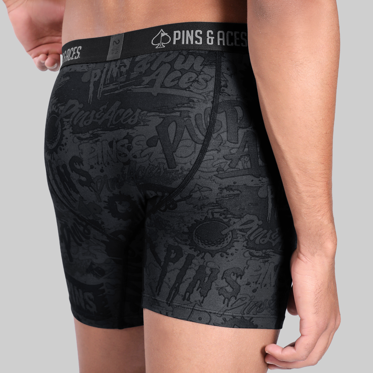 Men's 6" box briefs featuring a graffiti splatter design, showcasing a bold and stylish look for golfers.