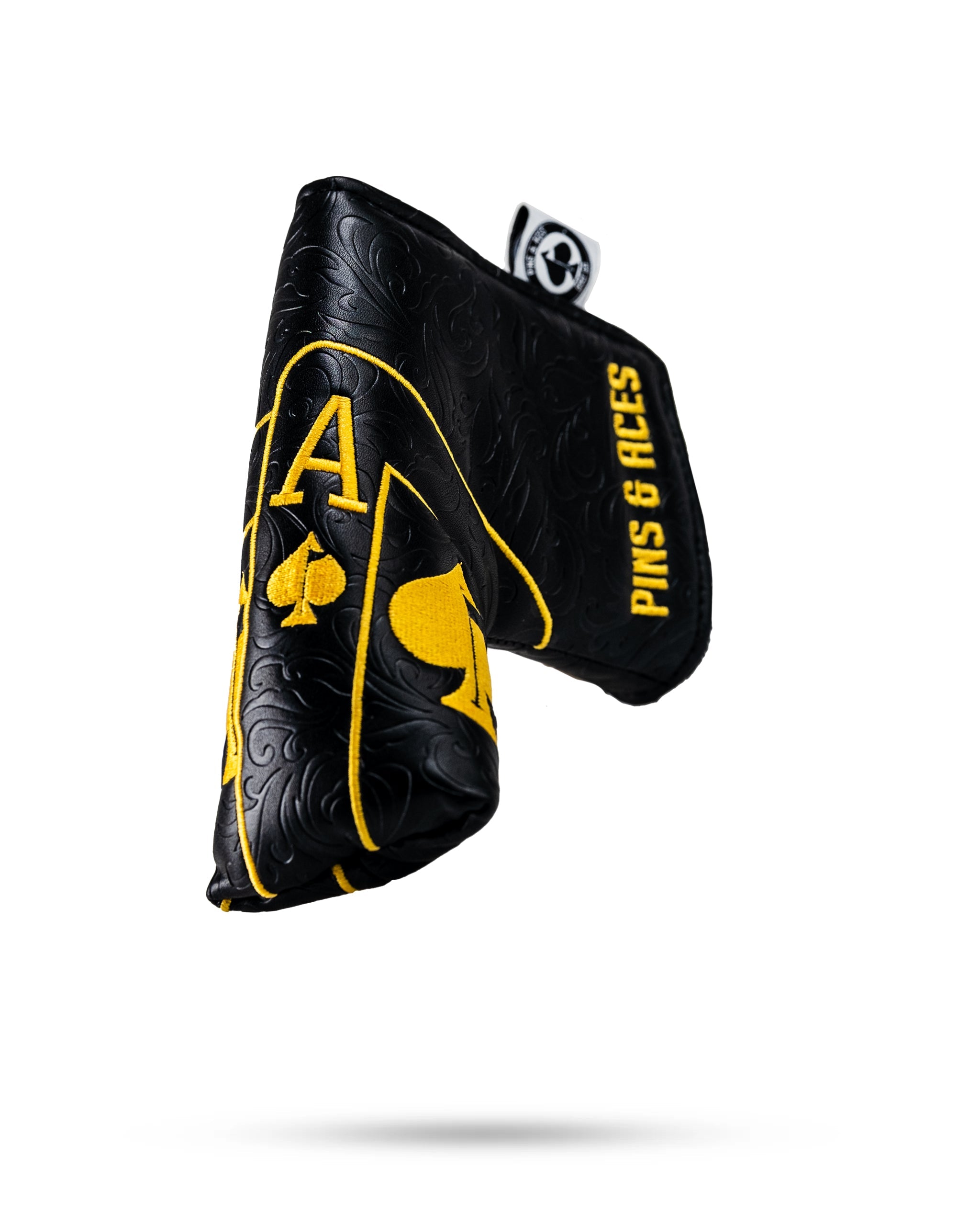 Black and gold Ace of Spades blade putter cover featuring a textured design and bold branding from Pins and Aces.