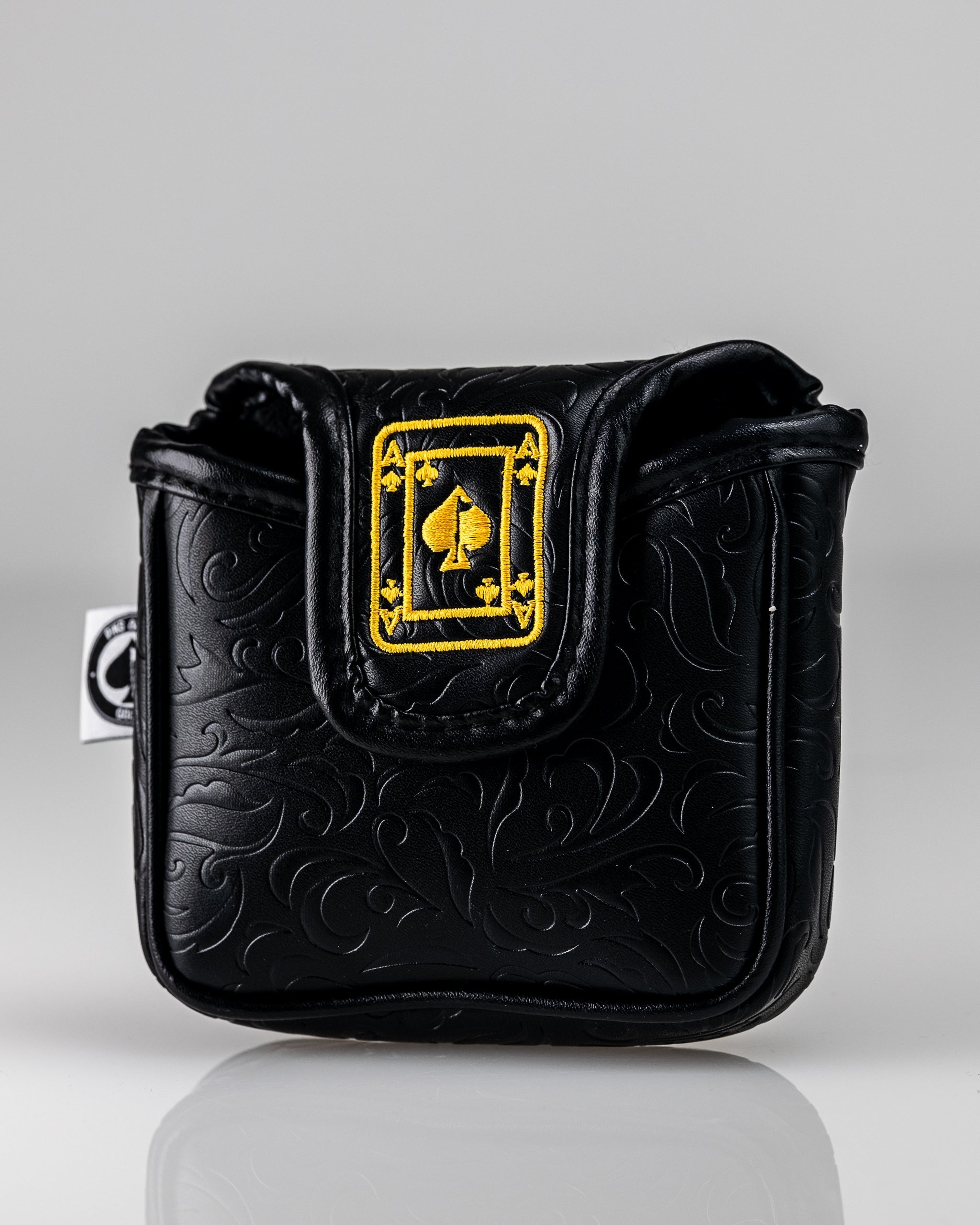 Black and gold mallet putter cover featuring an Ace of Spades design with intricate embossed detailing.