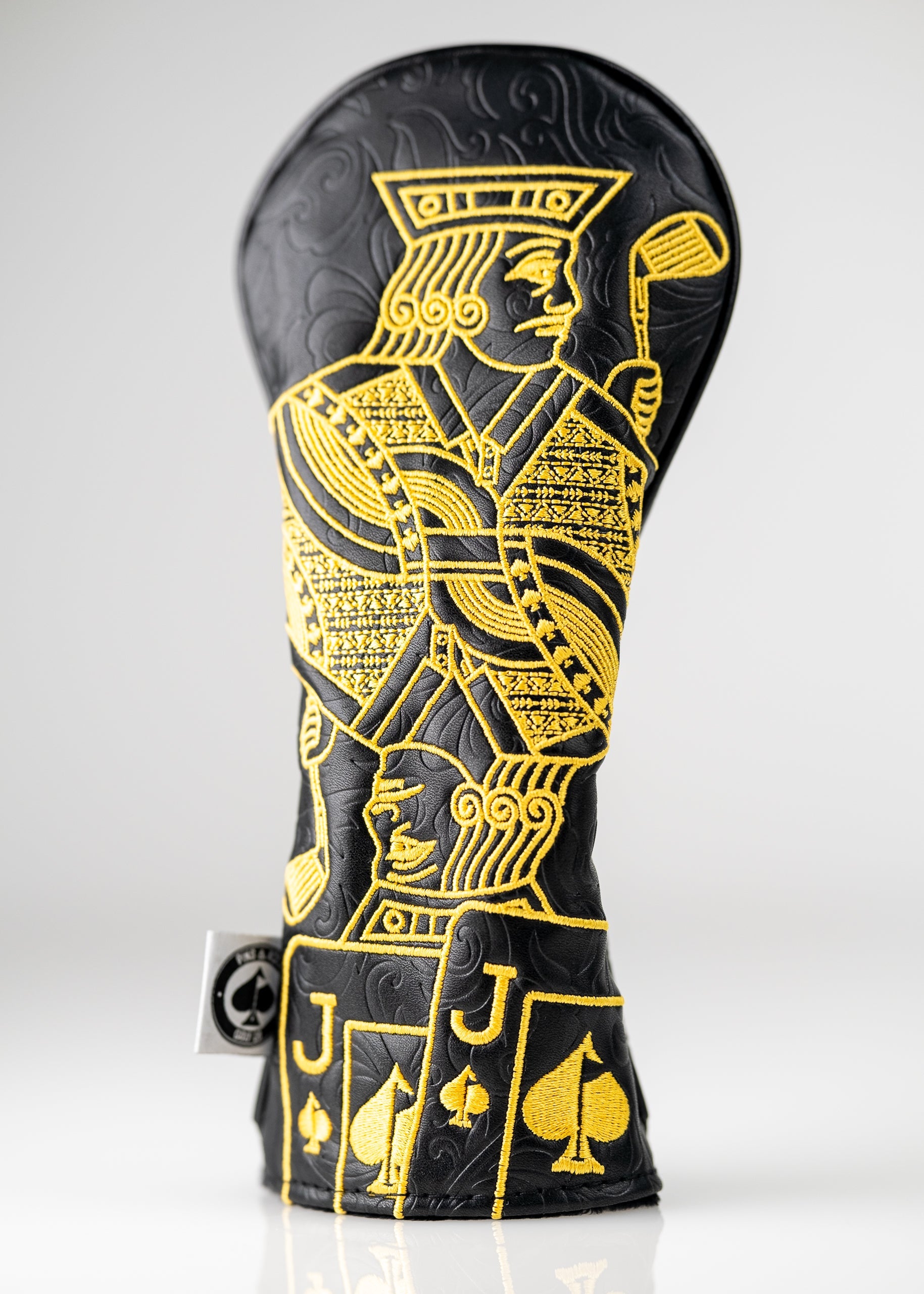 Black and gold hybrid golf headcover featuring a detailed Jack of Spades design, perfect for stylish golfers.