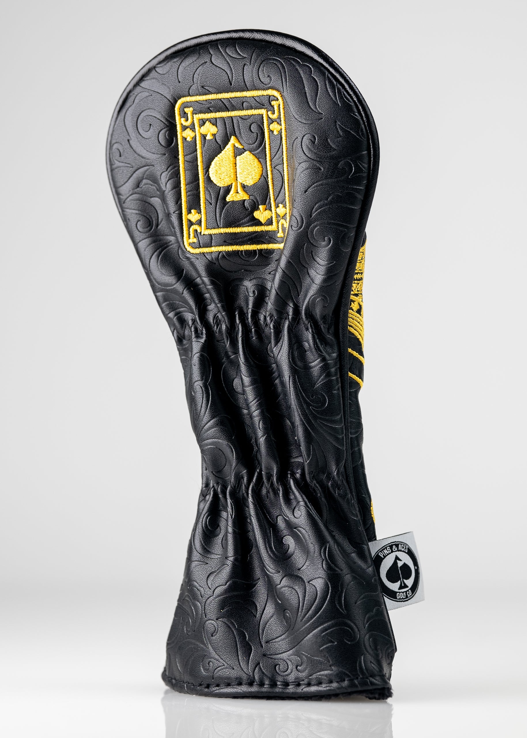 Black and gold hybrid golf cover featuring a detailed Jack of Spades design, perfect for stylish golfers.