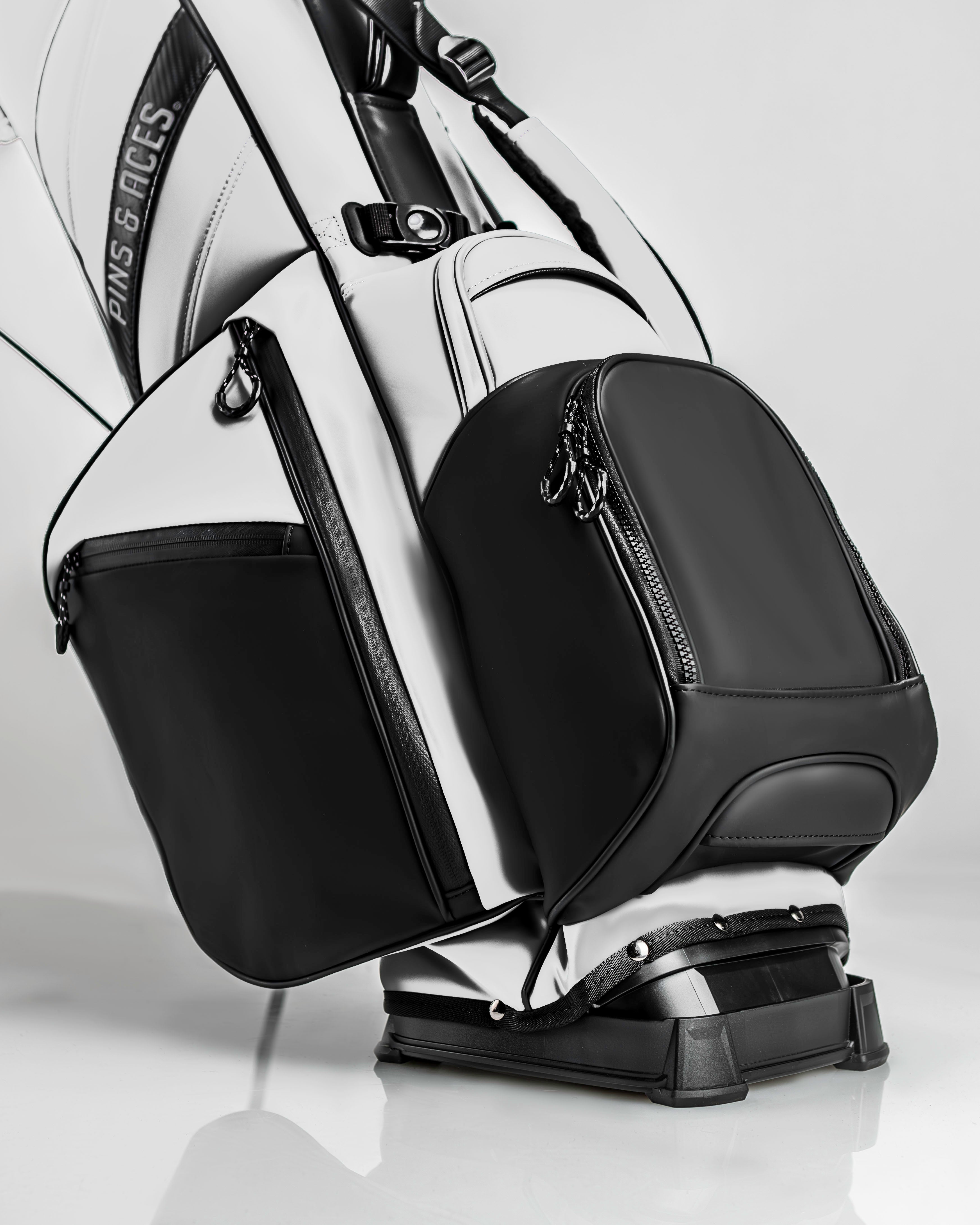 Stylish Player Preferred Golf Bag in white and black, featuring sleek design and multiple zippered pockets for storage.