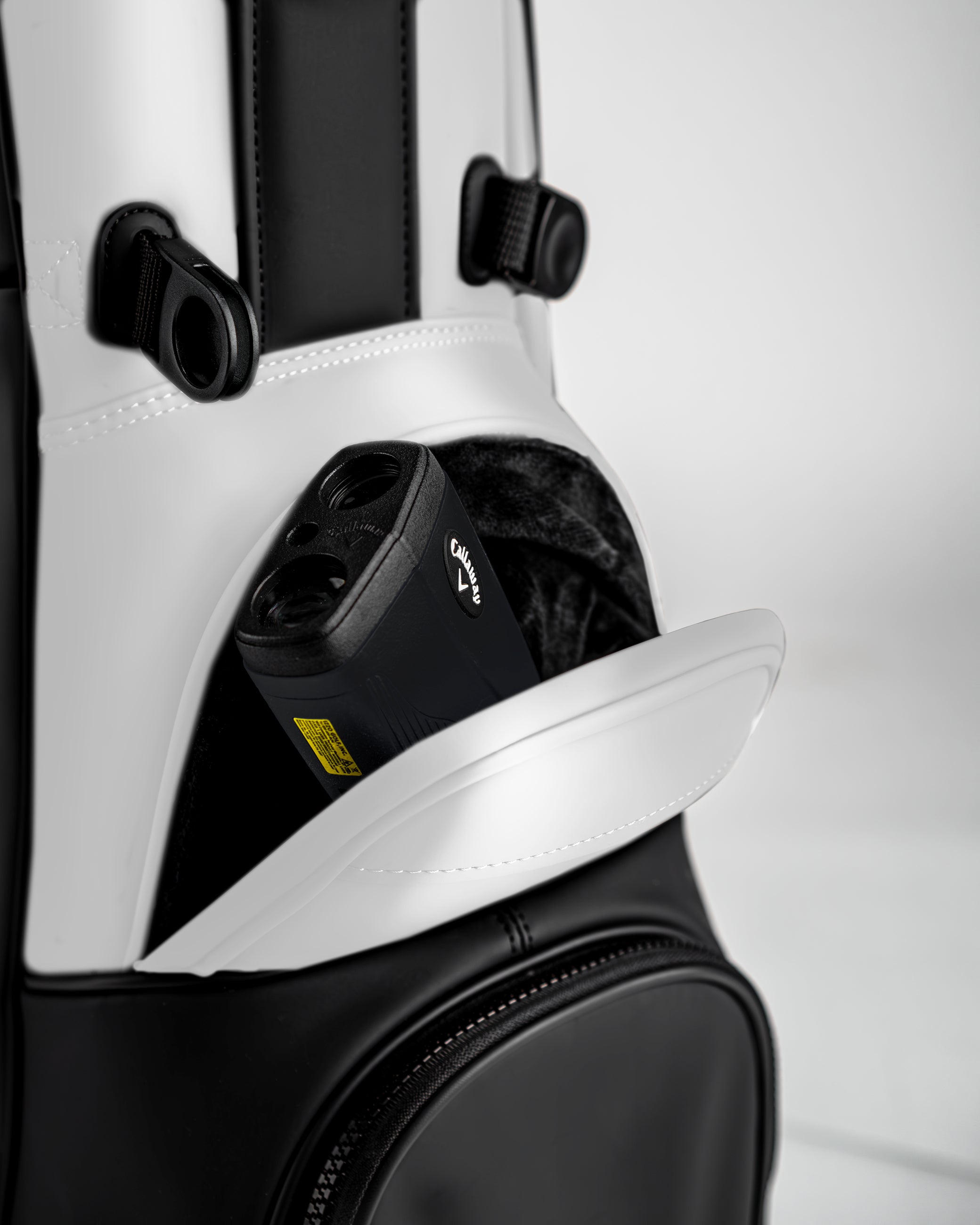 Close-up of the Player Preferred Golf Bag in Domino design, featuring a pocket with a golf rangefinder inside.