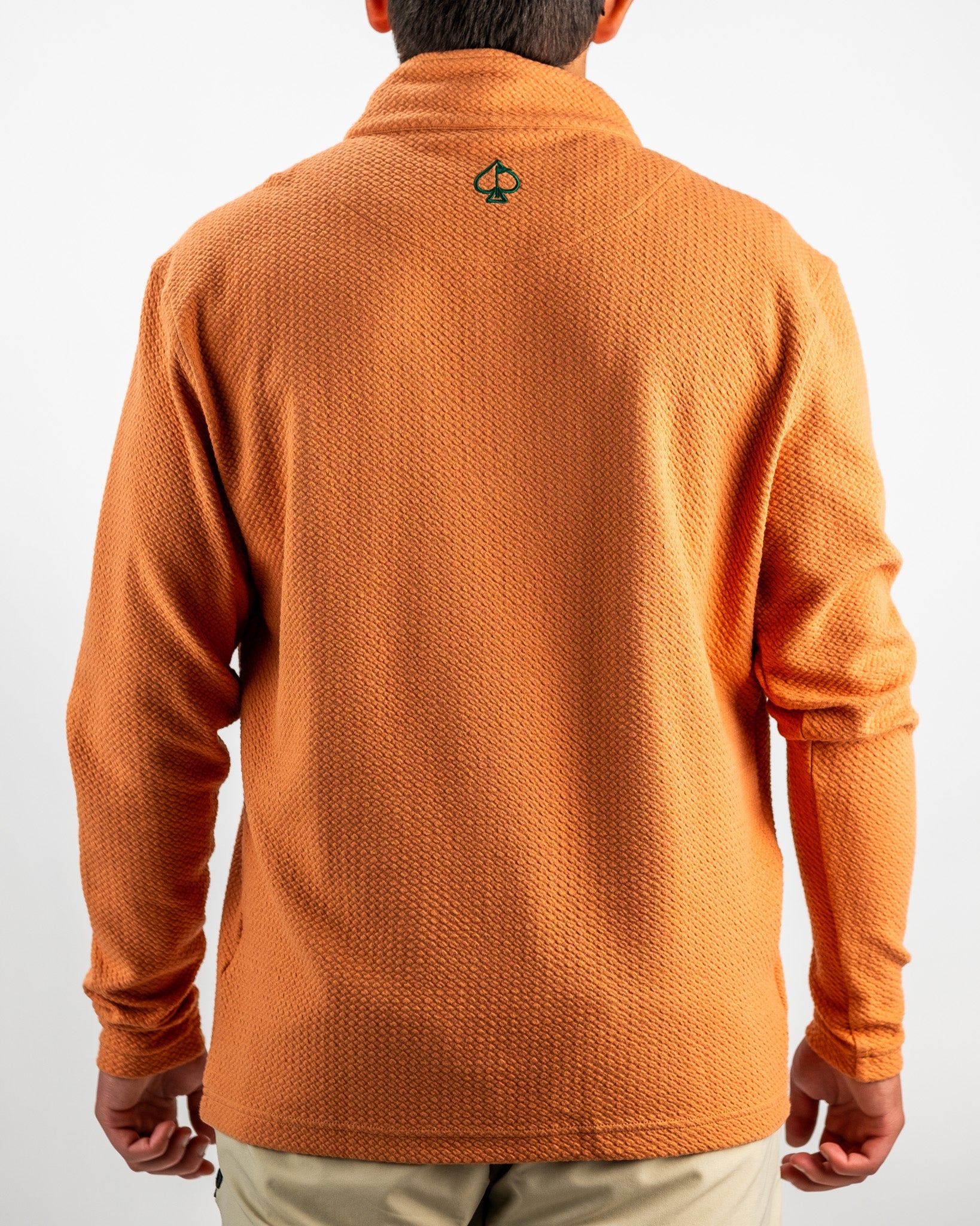 Men's pumpkin-colored Player Preferred Waffle Knit Pullover featuring a textured design and logo on the back.