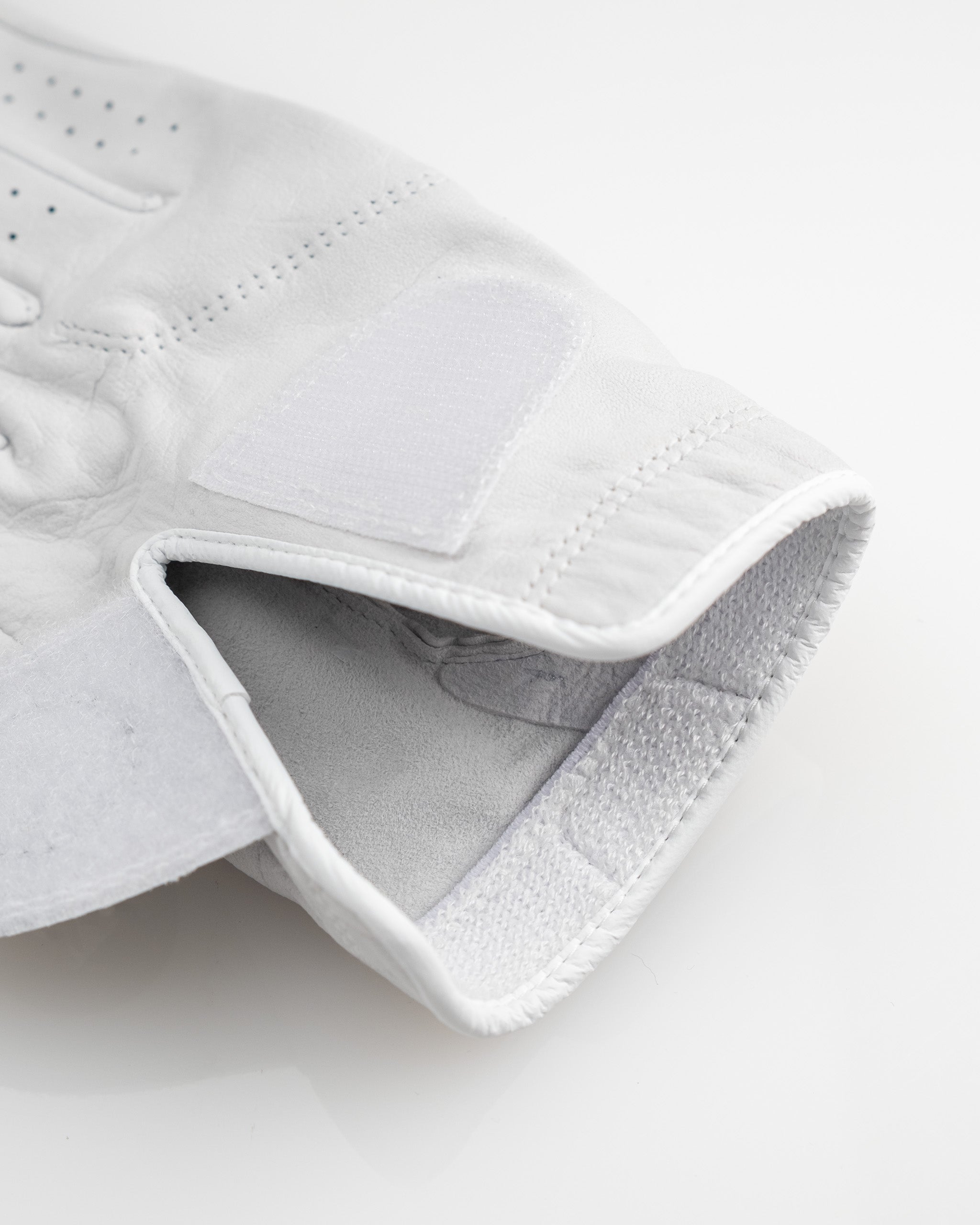 Premium Tour Glove in Ghost White featuring a sleek design and soft leather for optimal grip and comfort on the golf course.