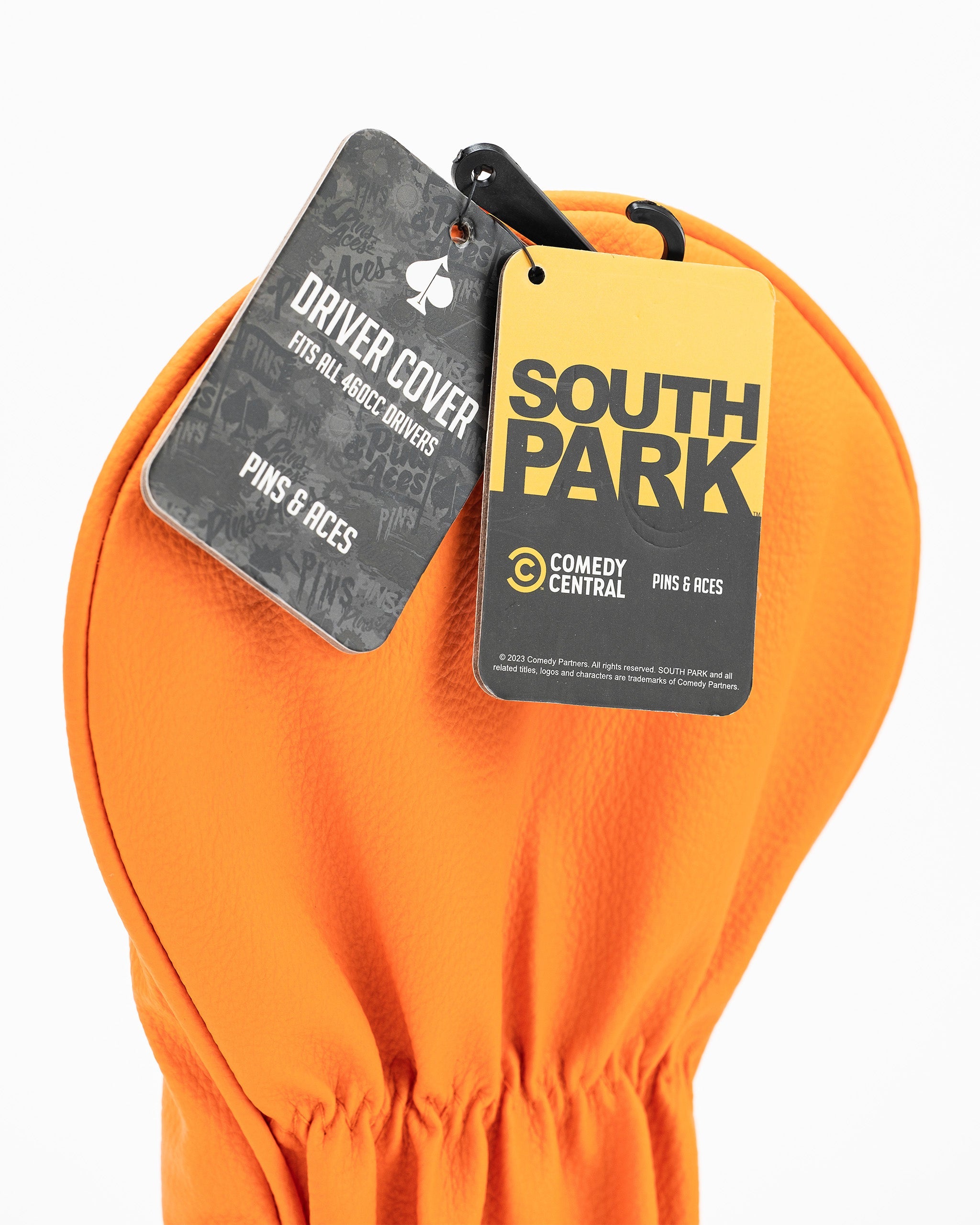 Kenny driver cover from South Park in bright orange, featuring tags for Pins and Aces and Comedy Central.