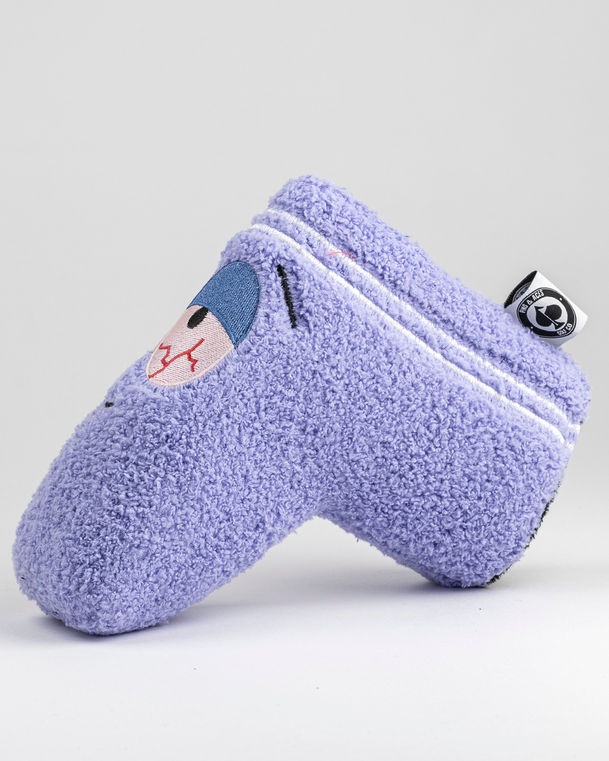 Purple towel putter cover featuring Towelie's face, designed for golfers seeking a fun and unique accessory on the course.