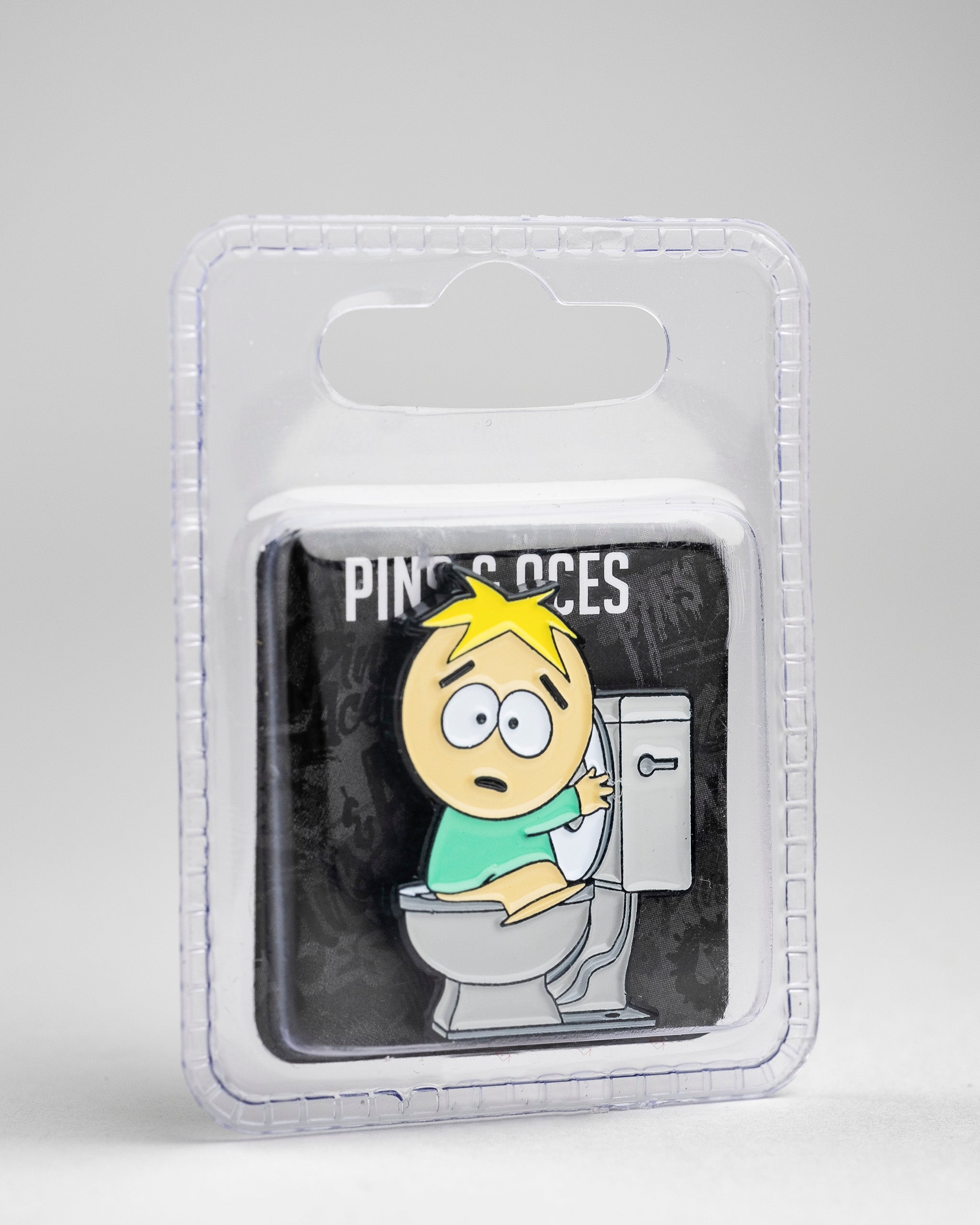 South Park Butters ball marker featuring the character sitting on a toilet, packaged in a clear plastic case.