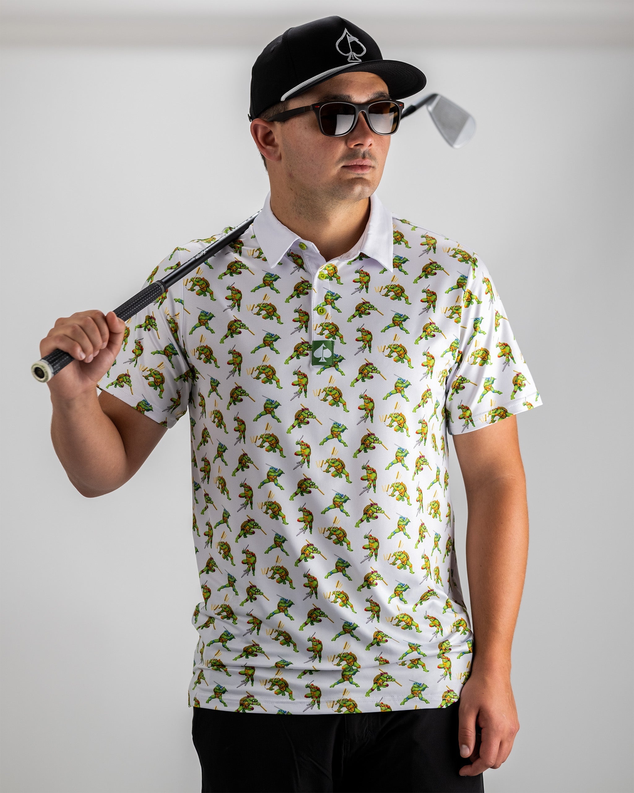 Men's golf polo featuring an all-over print of classic TMNT characters in an 8-bit style, perfect for bold golfers.