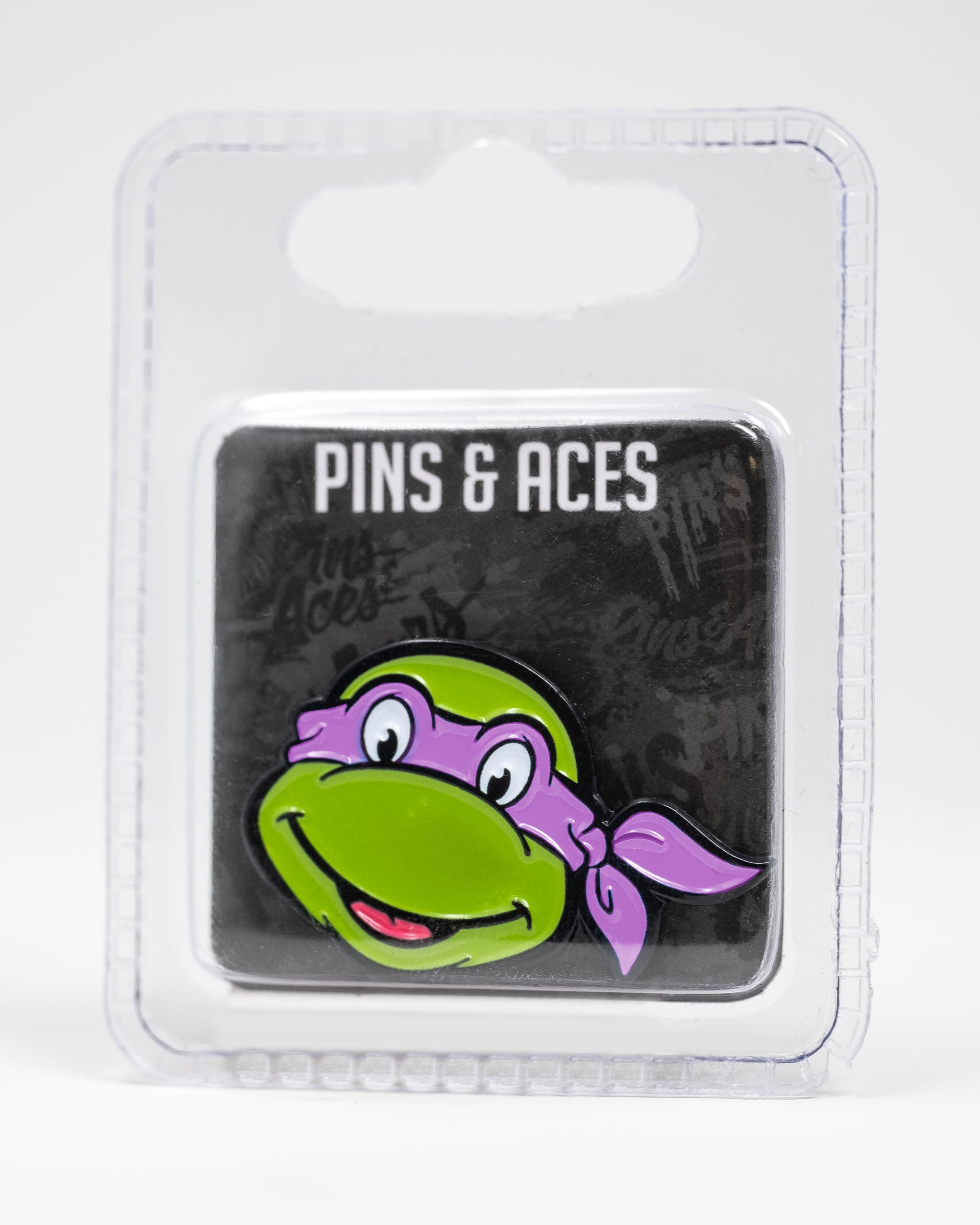 TMNT Donatello ball marker featuring a green turtle head with a purple bandana, packaged for golf enthusiasts.