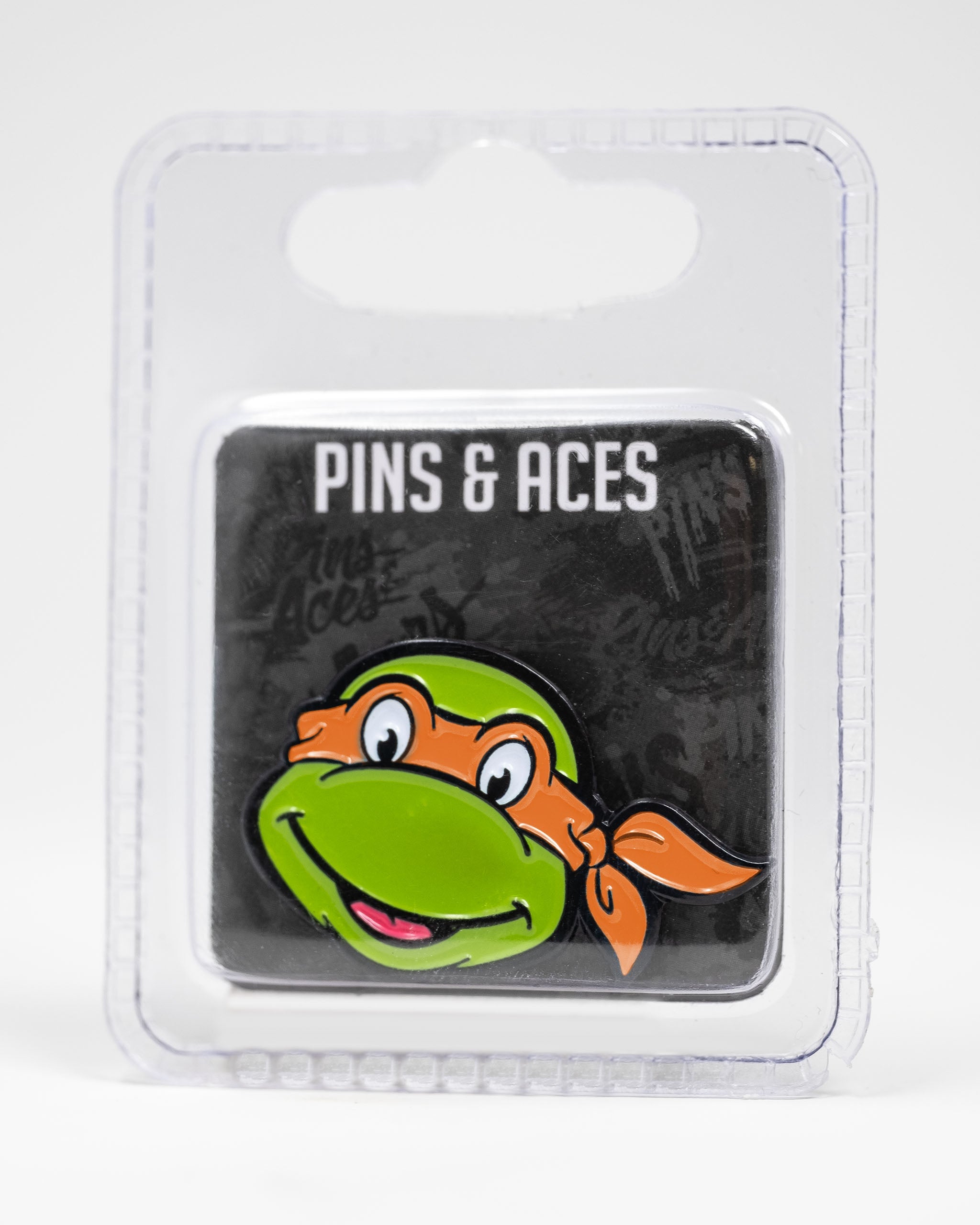 Michelangelo ball marker featuring a vibrant green turtle head with an orange bandana, packaged for golf enthusiasts.