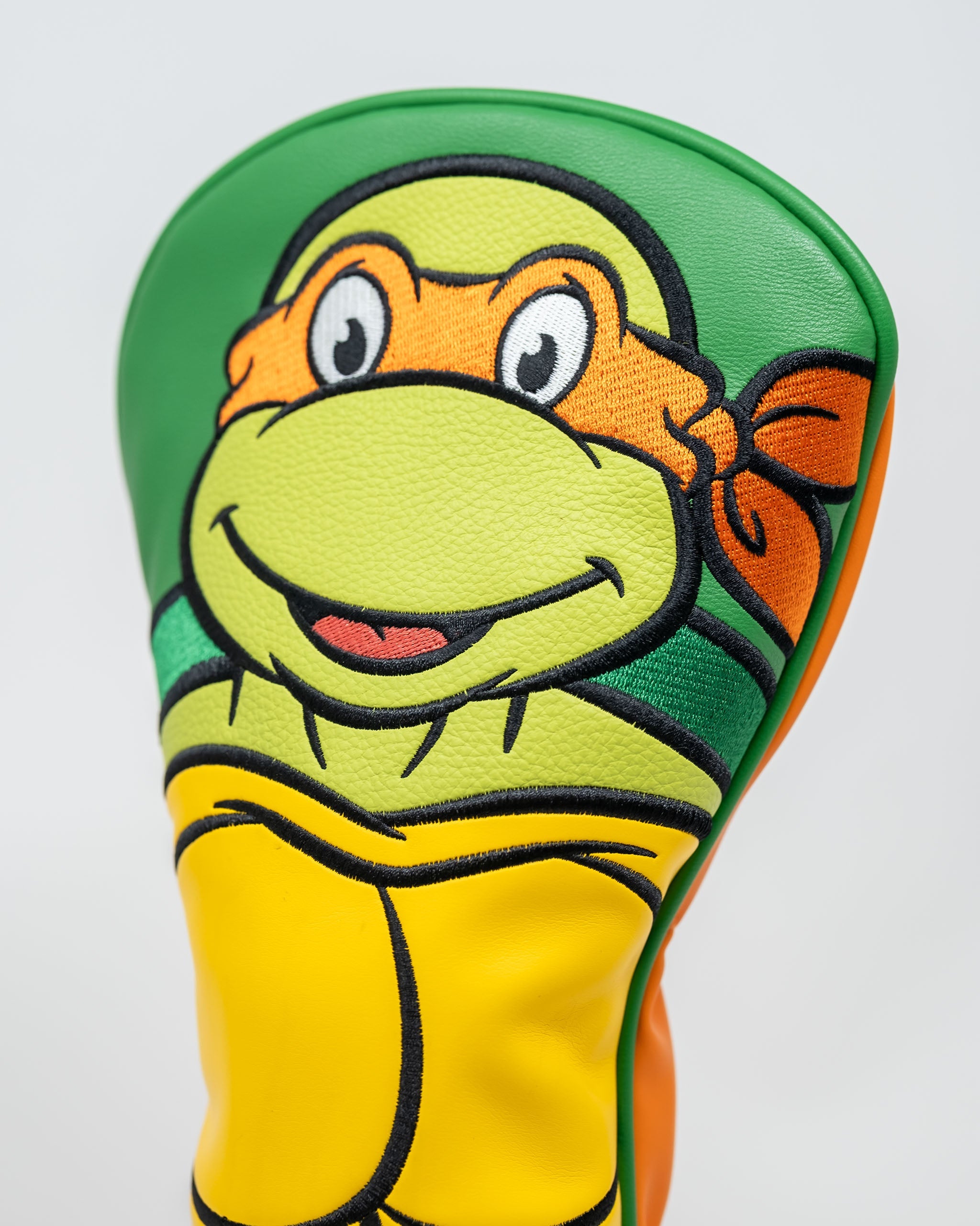 Michelangelo driver cover featuring vibrant colors and a playful design of the Teenage Mutant Ninja Turtles character.