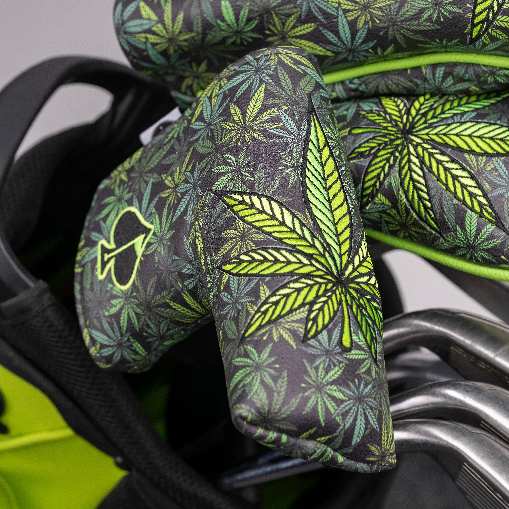Bold golf headcover featuring vibrant green and black cannabis leaf pattern, perfect for stand-out golf accessories.