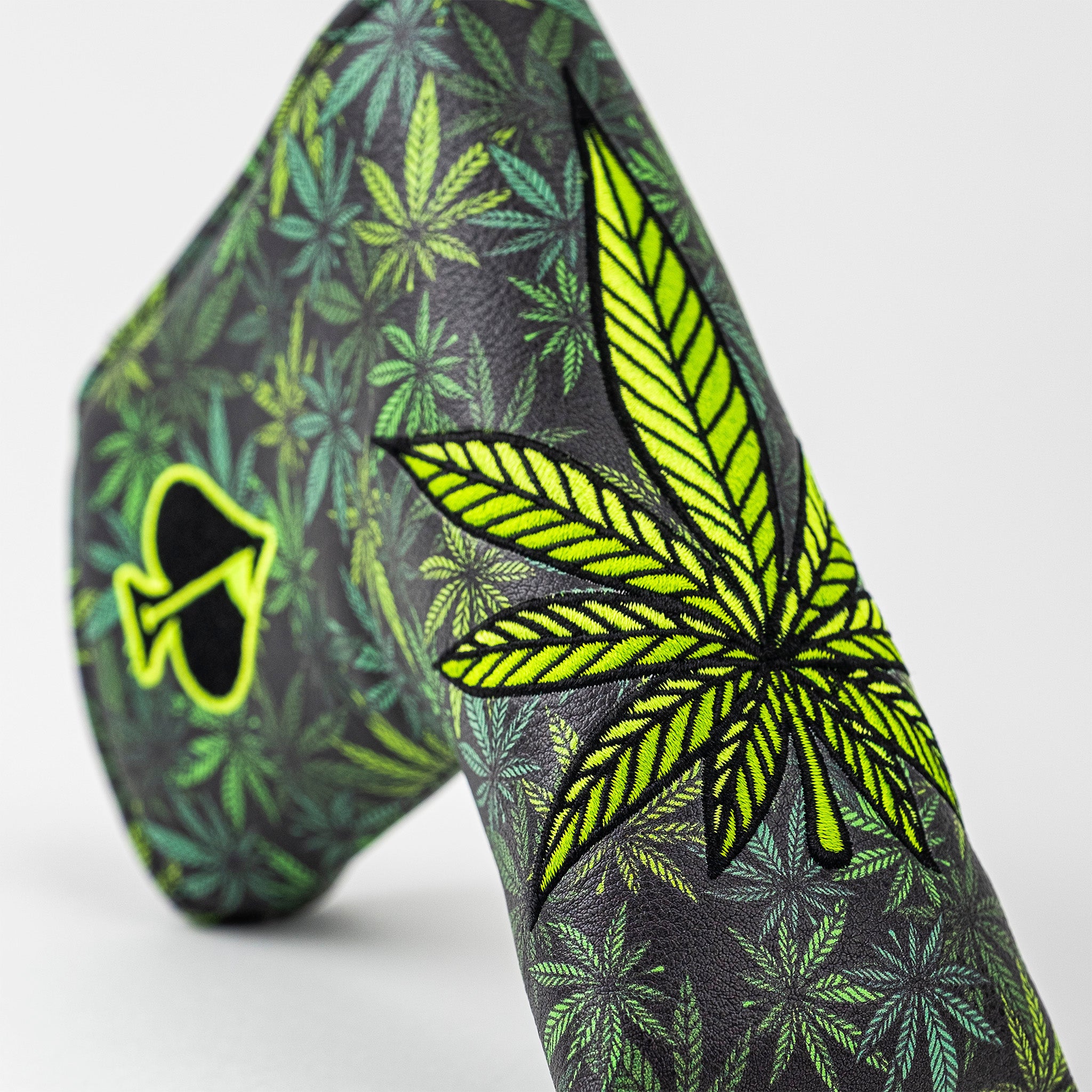 Bright green and yellow cannabis leaf pattern headcover with black background, bold and unique golf accessory for standout...