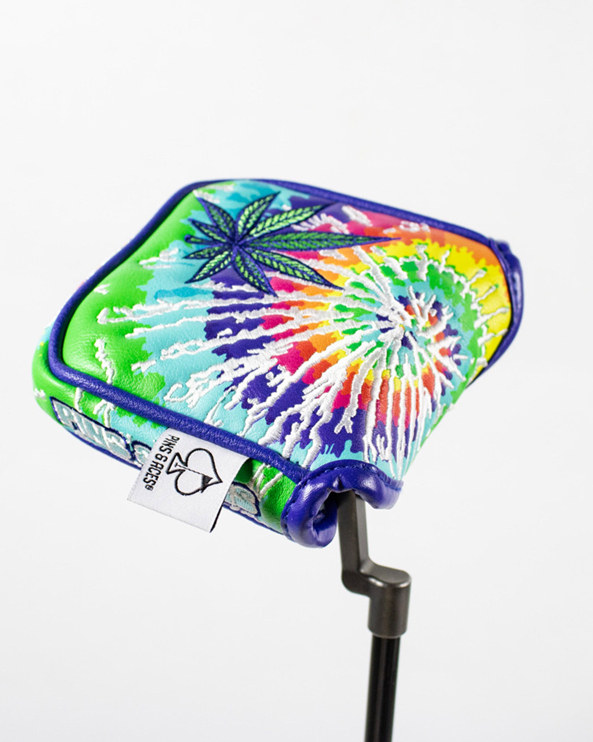 Colorful Puff Puff Putt mallet putter cover featuring a tie-dye design and cannabis leaf embroidery.