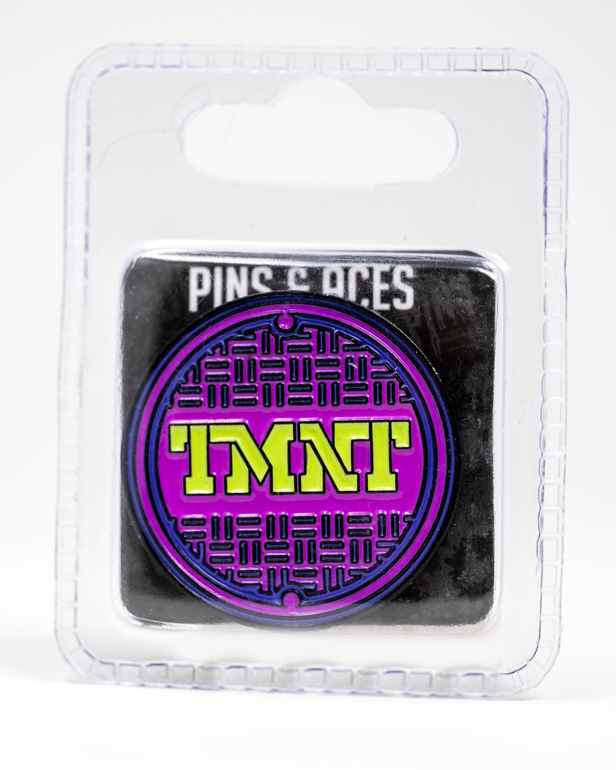 TMNT sewer cover ball marker featuring a vibrant purple and green design, perfect for fans on the golf course.