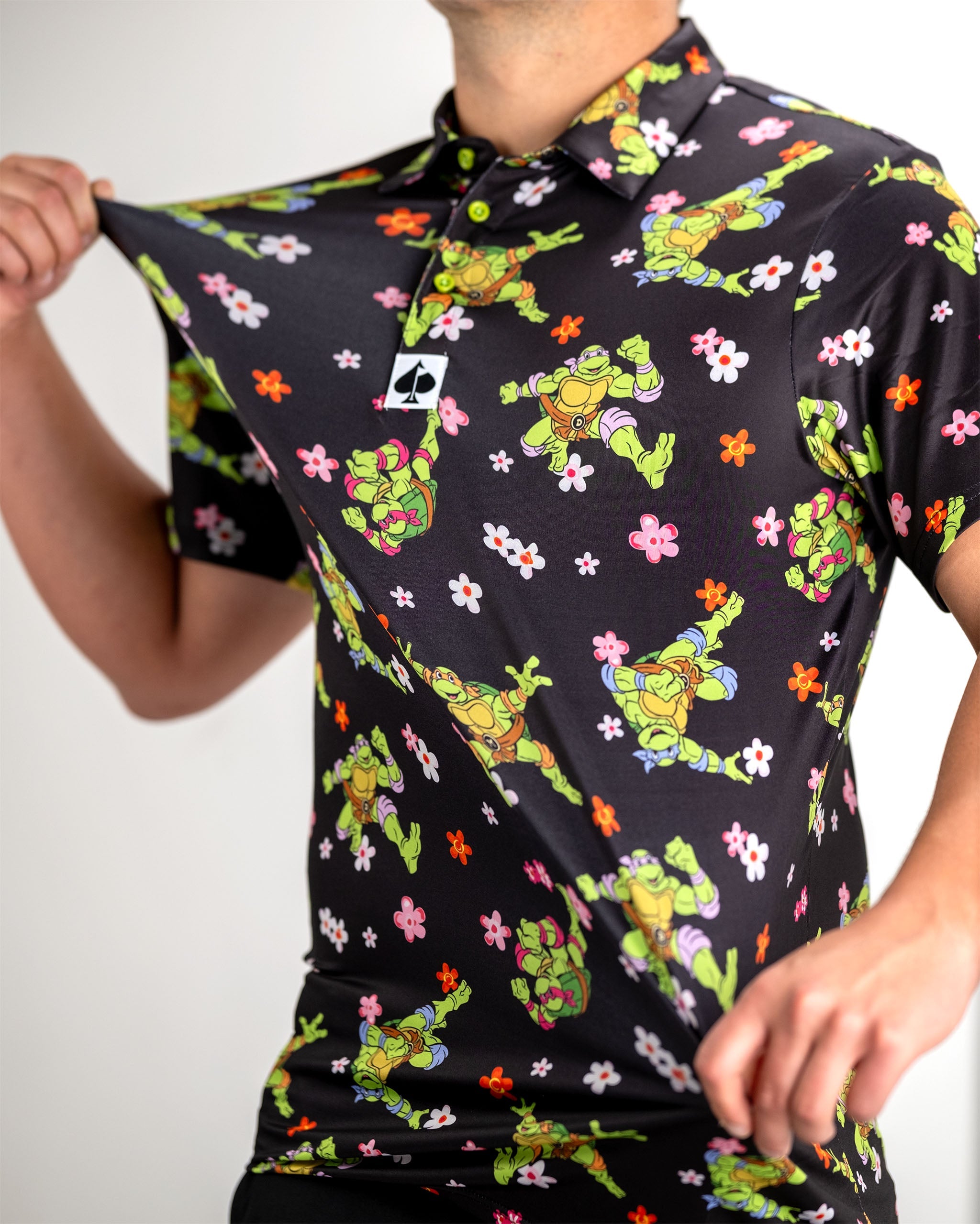 Bold TMNT golf polo featuring vibrant turtle and flower patterns, perfect for stylish golfers who want to stand out.
