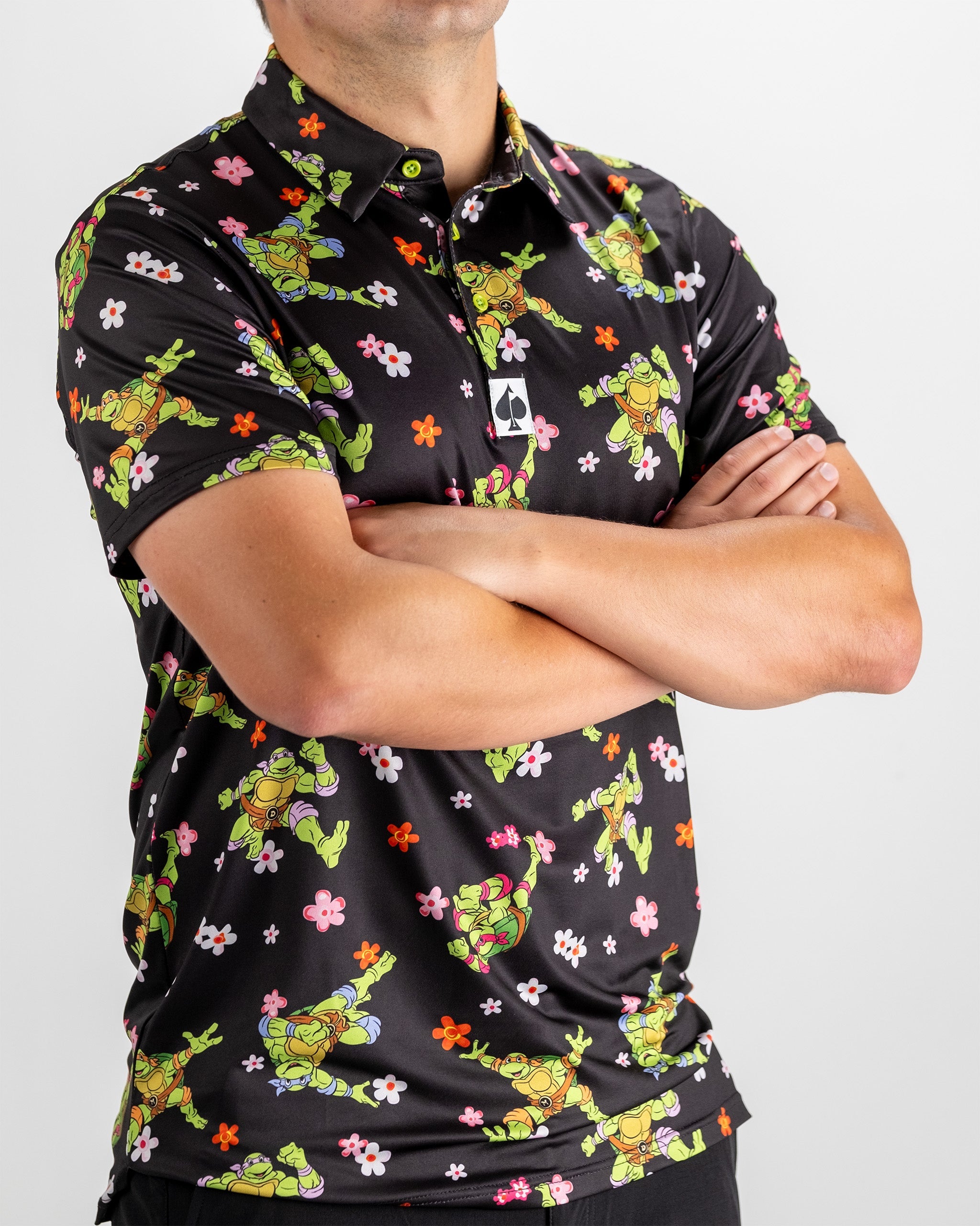 Bold TMNT golf polo featuring colorful turtle graphics and floral patterns, perfect for stylish golfers.