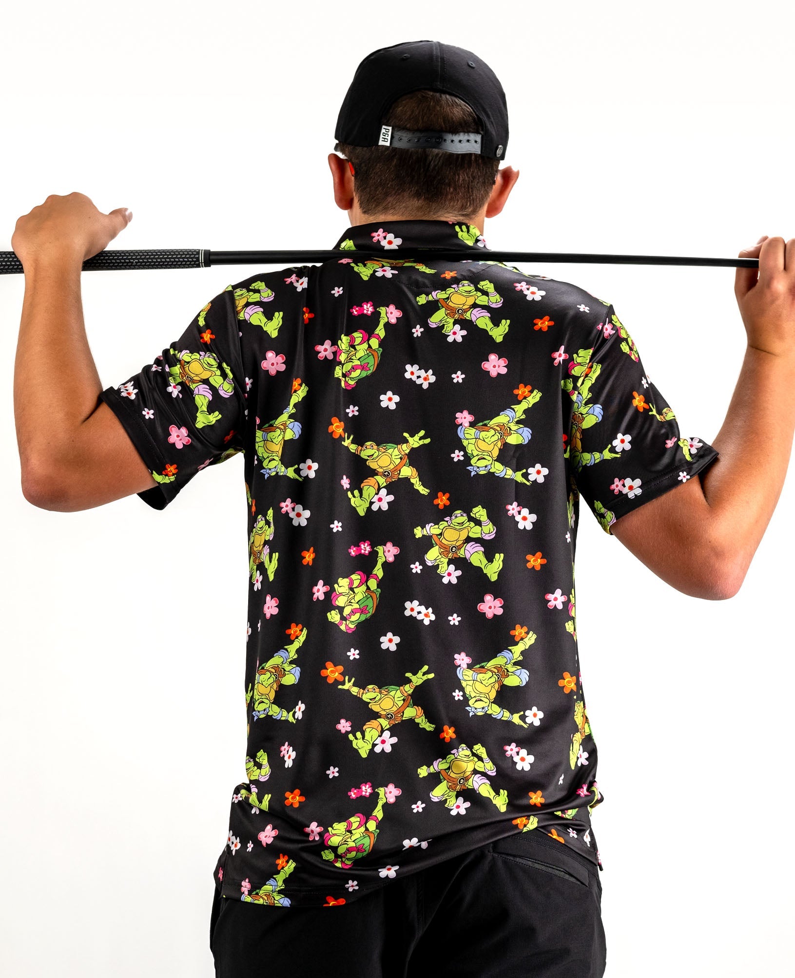 Bold TMNT golf shirt featuring vibrant turtle and flower patterns, perfect for stylish golfers who want to stand out.