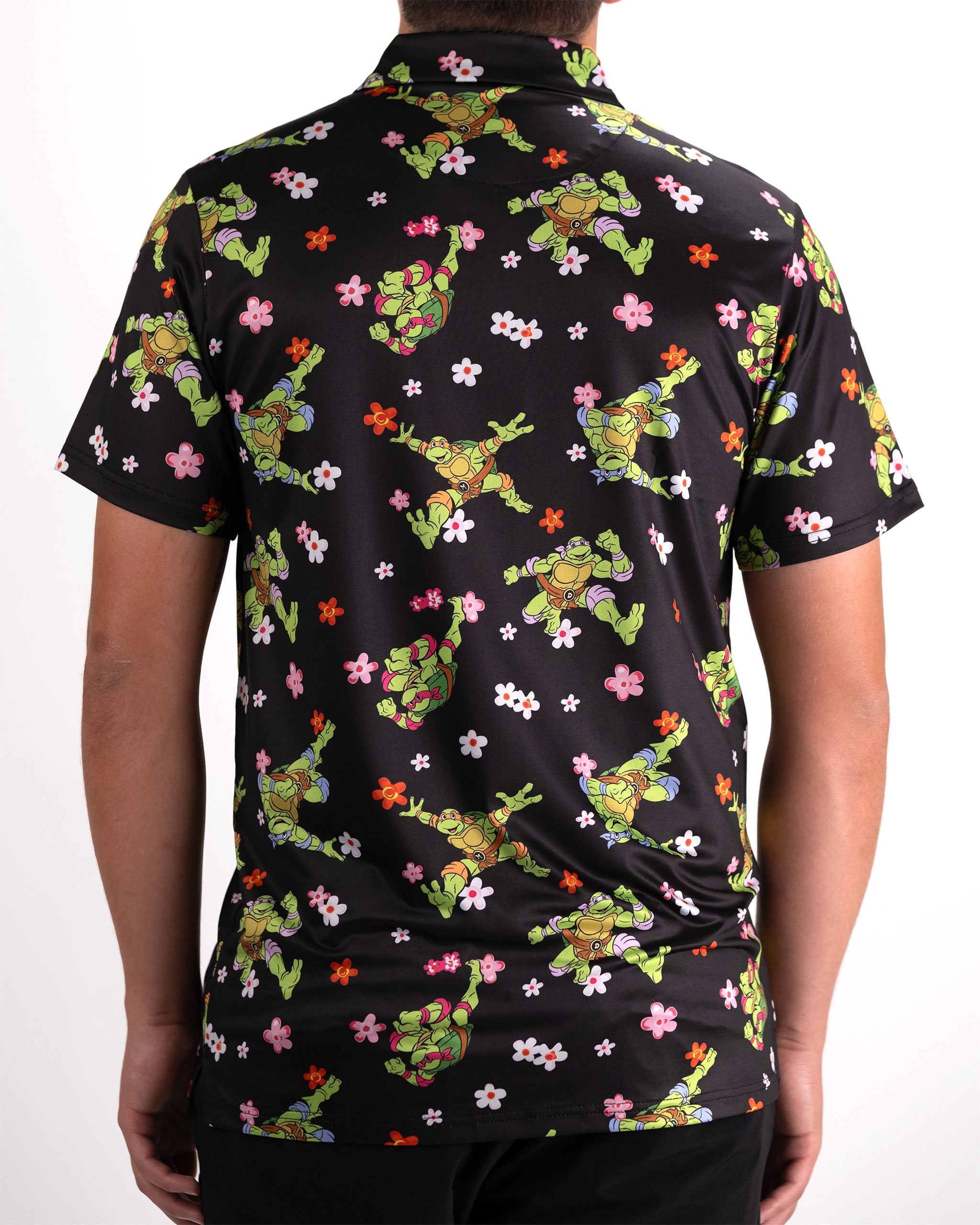 Men's black polo shirt featuring a colorful Teenage Mutant Ninja Turtles design with flowers, perfect for bold golf style.