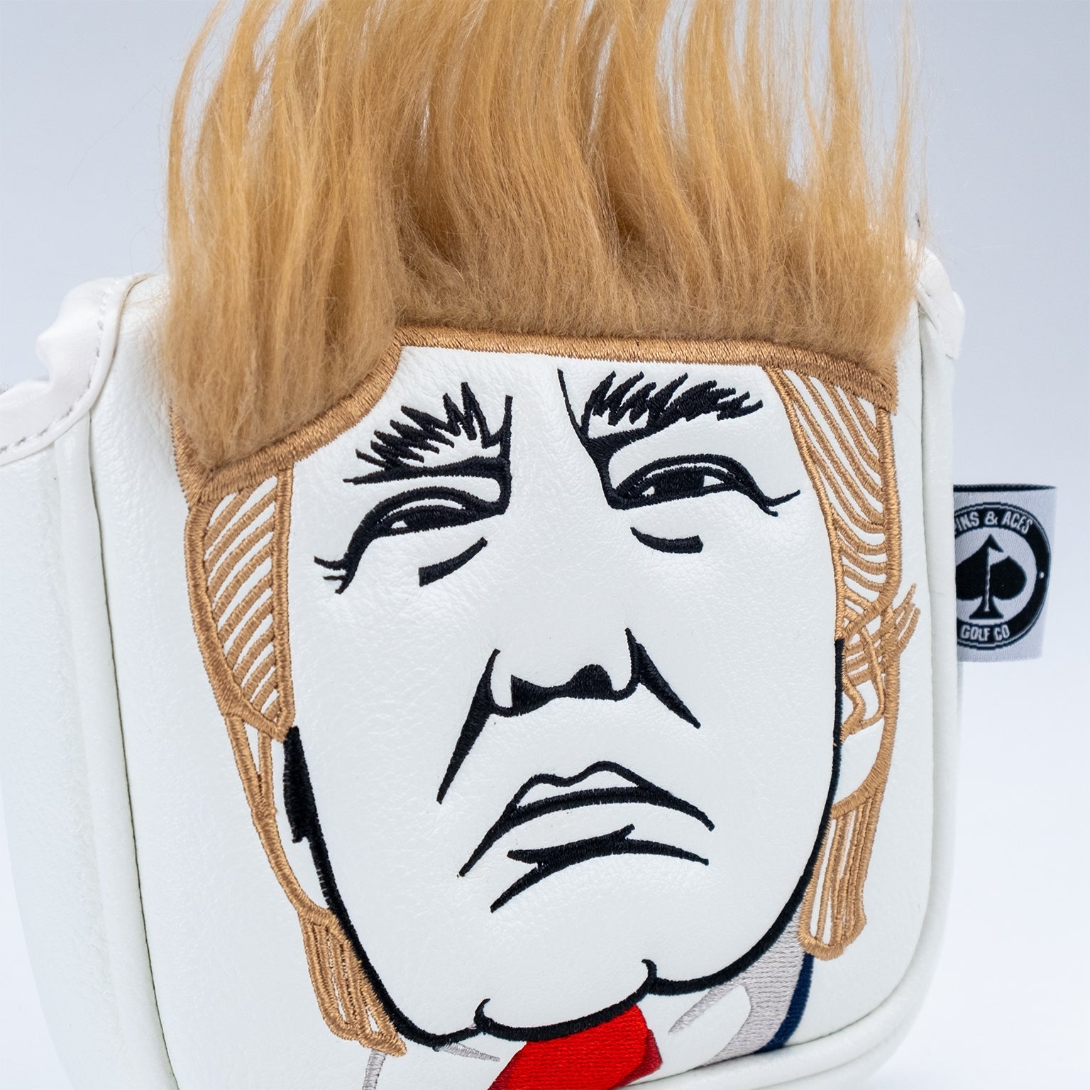 Mallet putter cover featuring a caricature of a man with distinctive hair and facial features, designed for bold golfers.