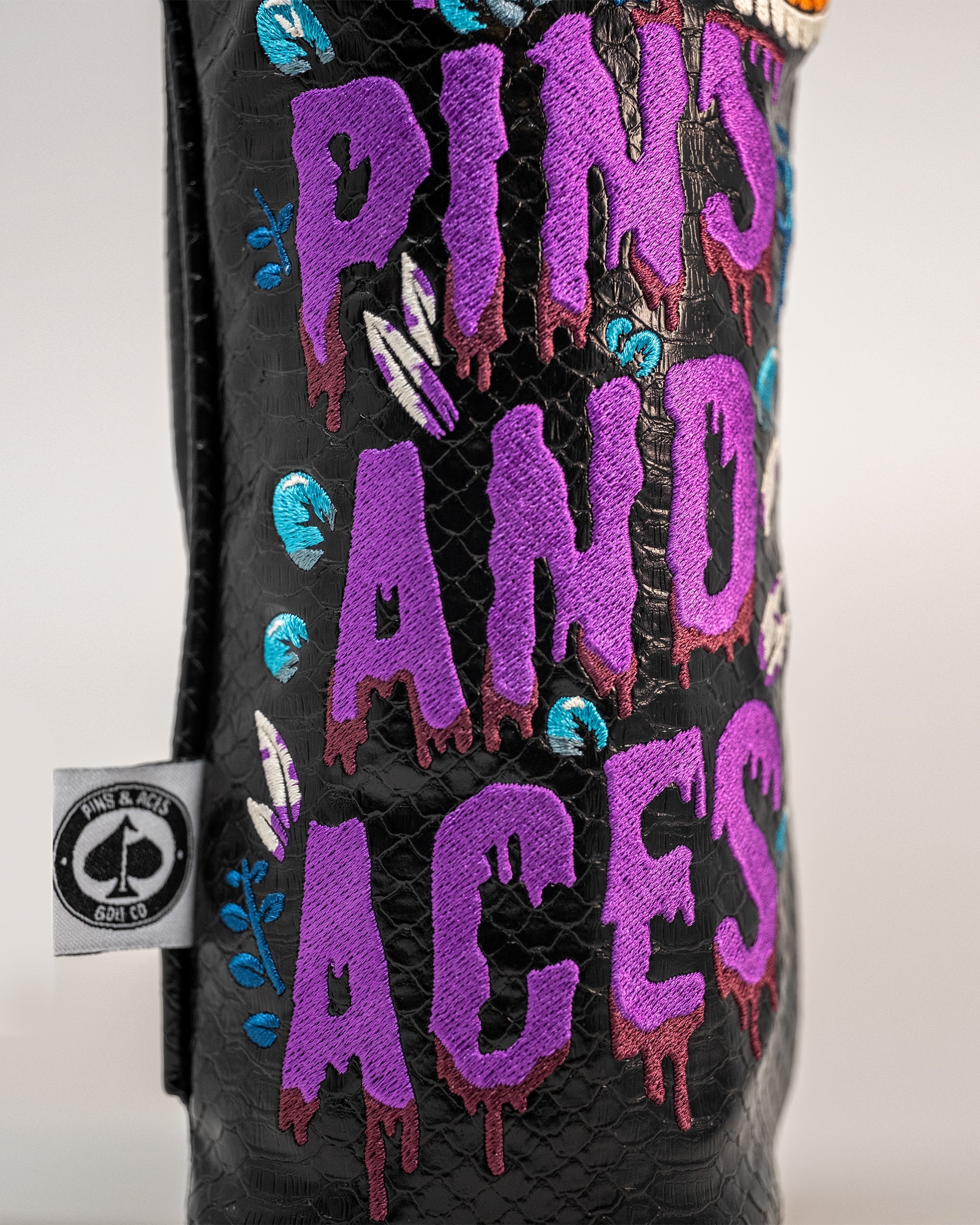 Bold Venom Driver Cover featuring vibrant embroidered text and colorful floral accents, perfect for standout golf style.